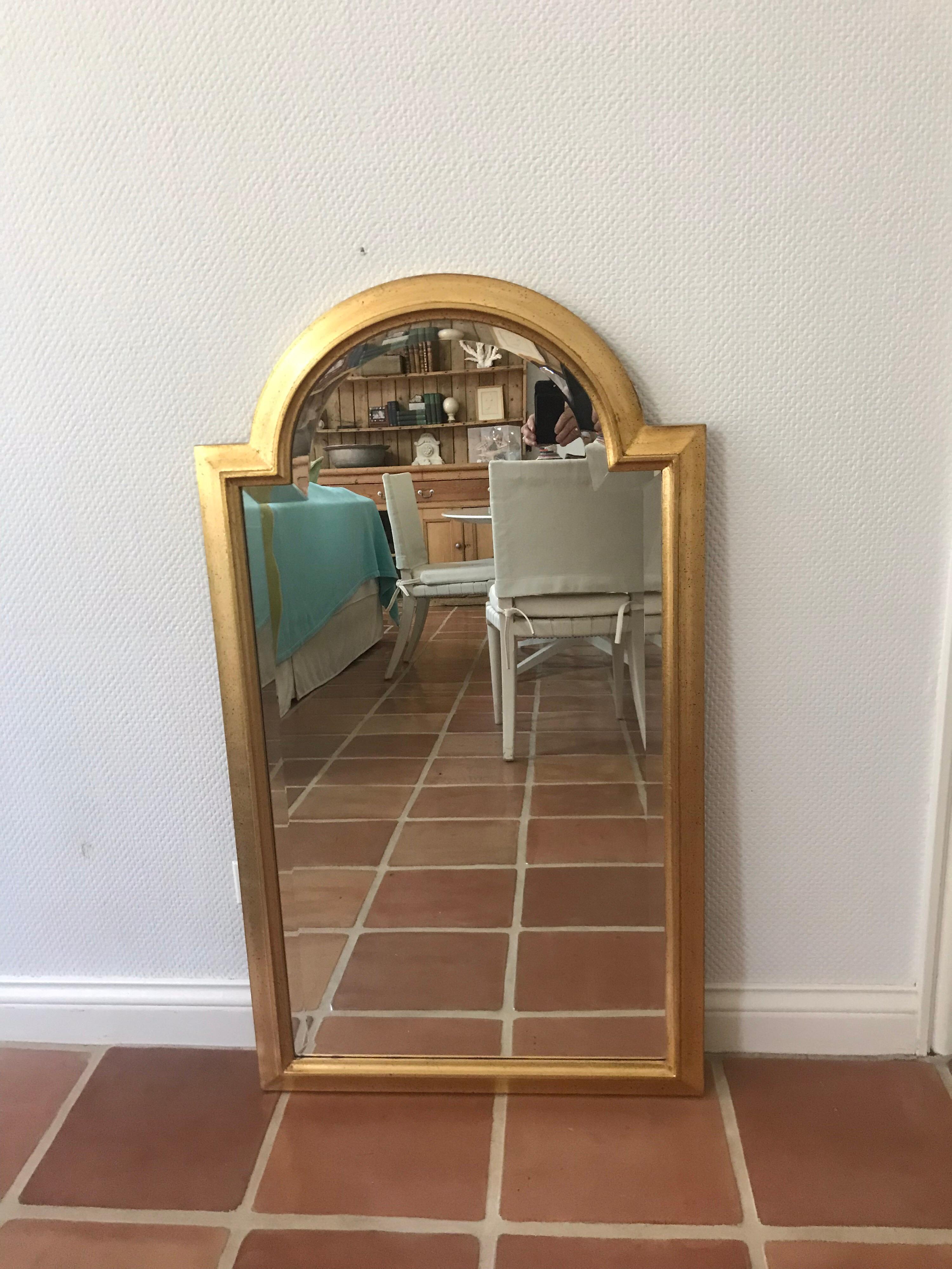 This is a vintage 1970s-1980s beveled glass and giltwood mirror made in Italy by LaBarge Co.