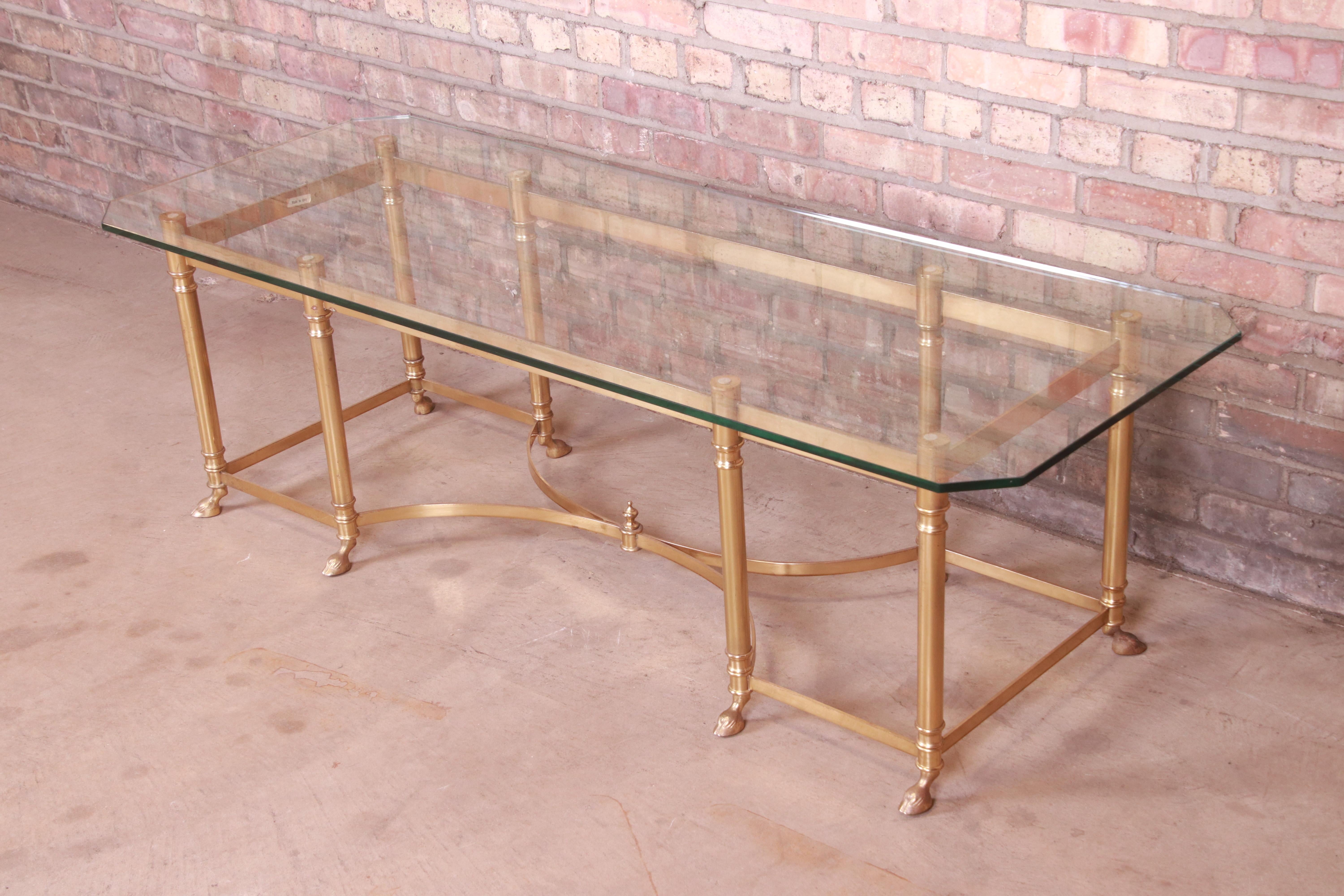 A gorgeous Mid-Century Modern Hollywood Regency hooved feet coffee or cocktail table

By Labarge

Italy, Circa 1960s

Solid brass frame, with glass top.

Measures: 60