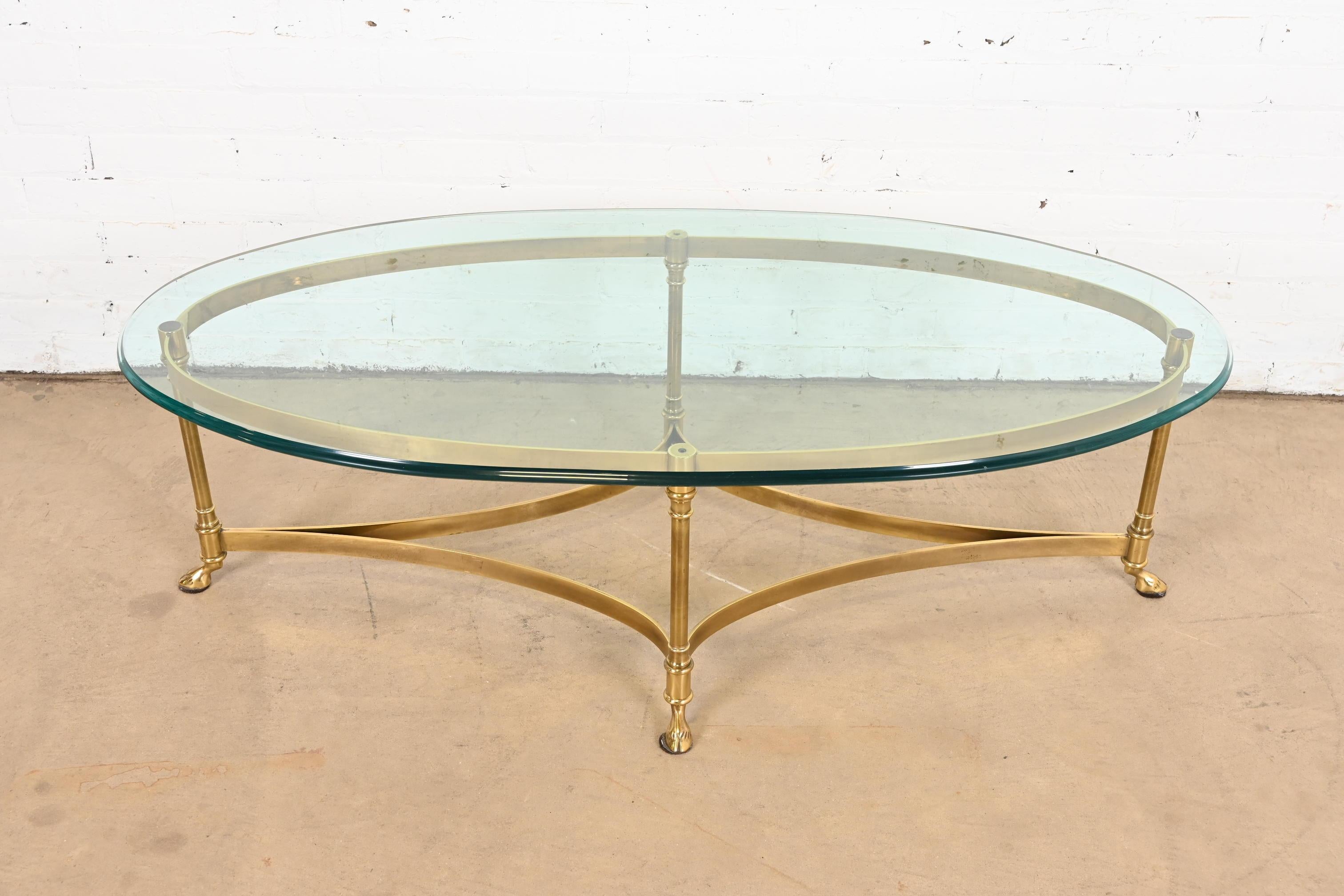 A gorgeous Mid-Century Modern Hollywood Regency brass and glass hooved feet coffee or cocktail table

By Labarge

Circa 1960s

Solid brass base, with beveled glass top.

Measures: 51.5