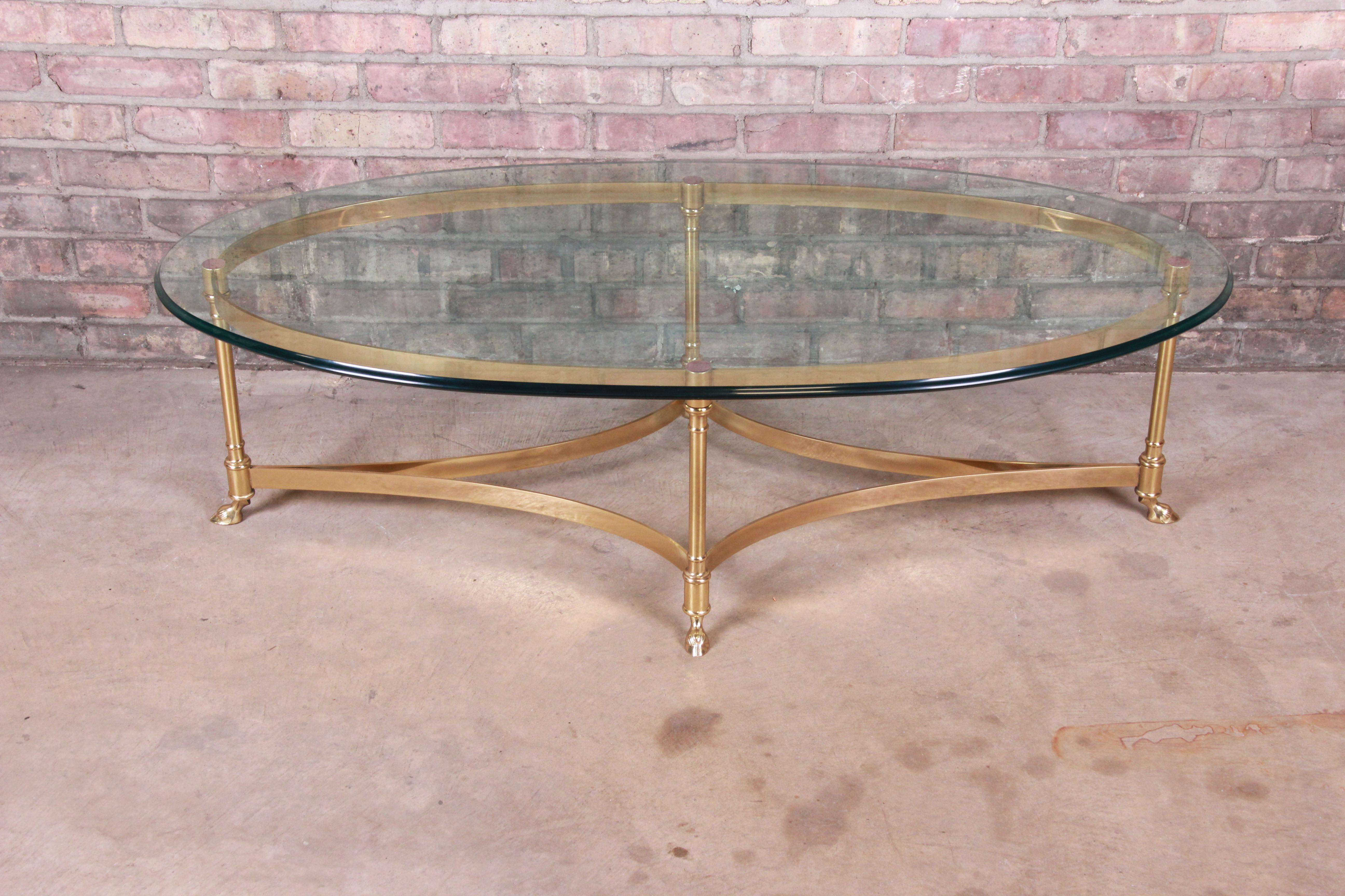 A gorgeous Mid-Century Modern Hollywood Regency hooved feet coffee or cocktail table

By Labarge

circa 1960s

Solid brass base with thick beveled glass top.

Measures: 51.75