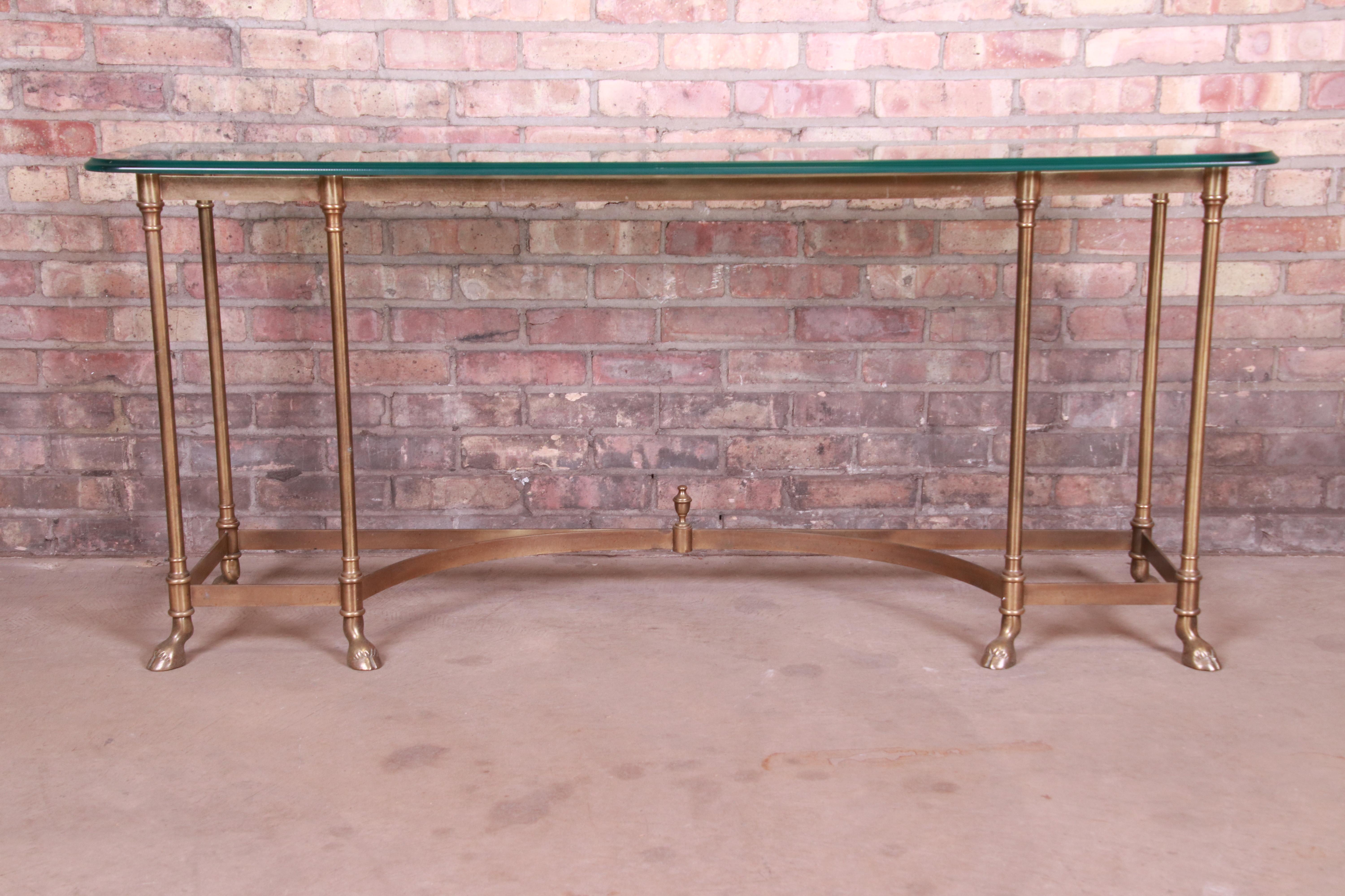 A gorgeous Mid-Century Modern Hollywood Regency hooved feet console, entry table, or sofa table

By Labarge

circa 1960s

Solid brass frame, with beveled glass top.

Measures: 59