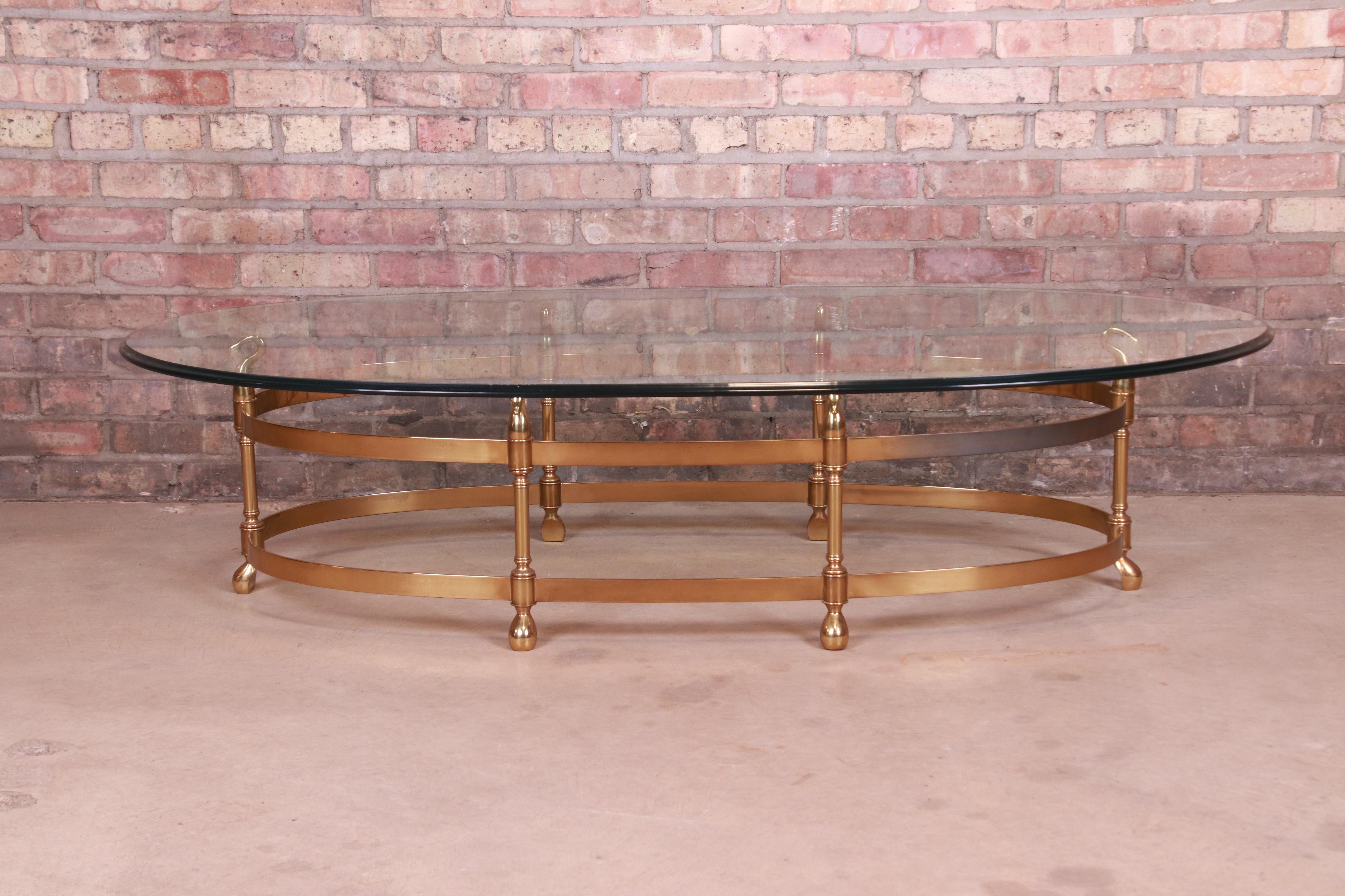 A gorgeous Mid-Century Modern Hollywood Regency oval coffee or cocktail table

By Labarge

Circa 1960s

Solid brass frame with swan motif and beveled glass top.

Measures: 61