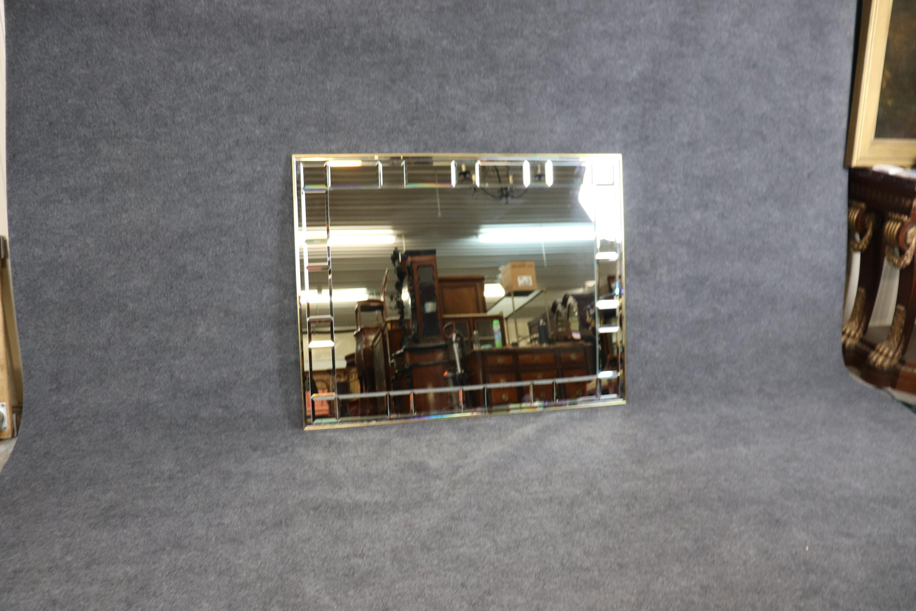 LaBarge of Michigan has always made some of the most beautiful mirrors for designers and decorators for generations. This Italian-made mirror features separate facets of mirrored glass within a brass frame. The mirror is in good condition and dates