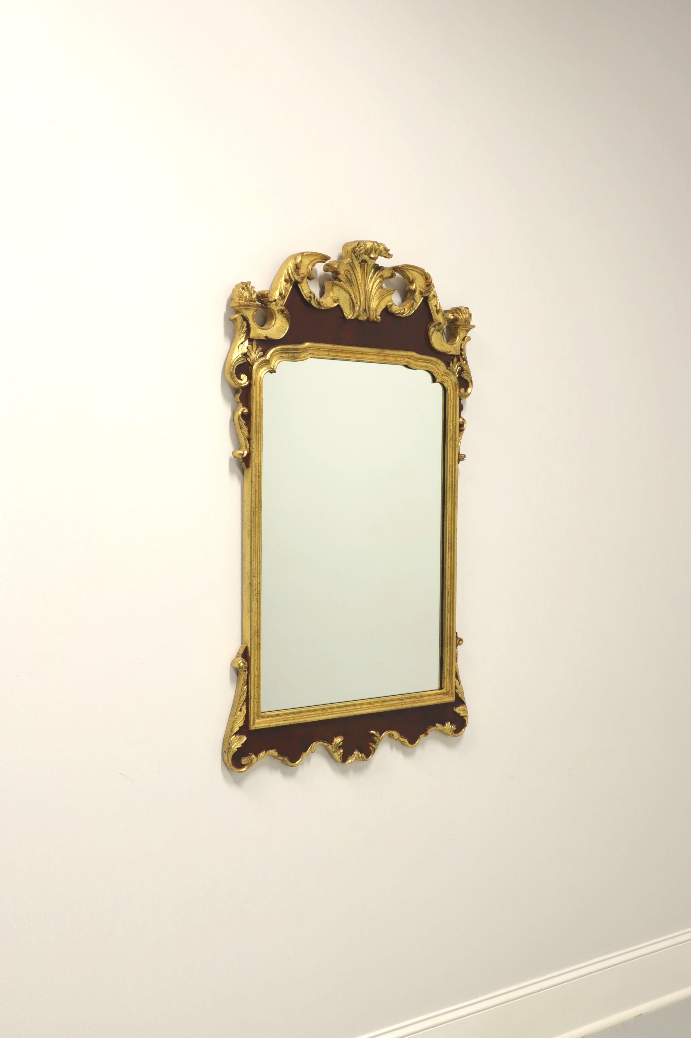 Miroir mural de style provincial français par Labarge. Verre miroir dans un cadre en bois peint en or et marron. La peinture dorée a été légèrement altérée pour donner l'apparence de l'âge. Le cadre est orné d'un motif décoratif sculpté. Fabriqué en