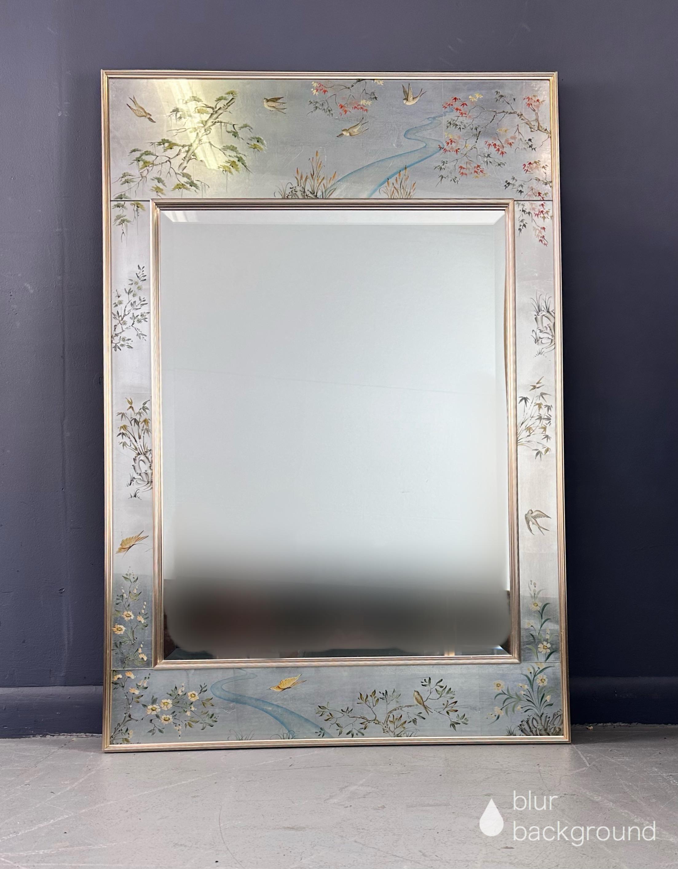 Chinoiserie style mirror with silver leaf eglomise panels depicting various nature scenes of flora and water falls. Panels surround a beveled mirror center, all in a metal surround.