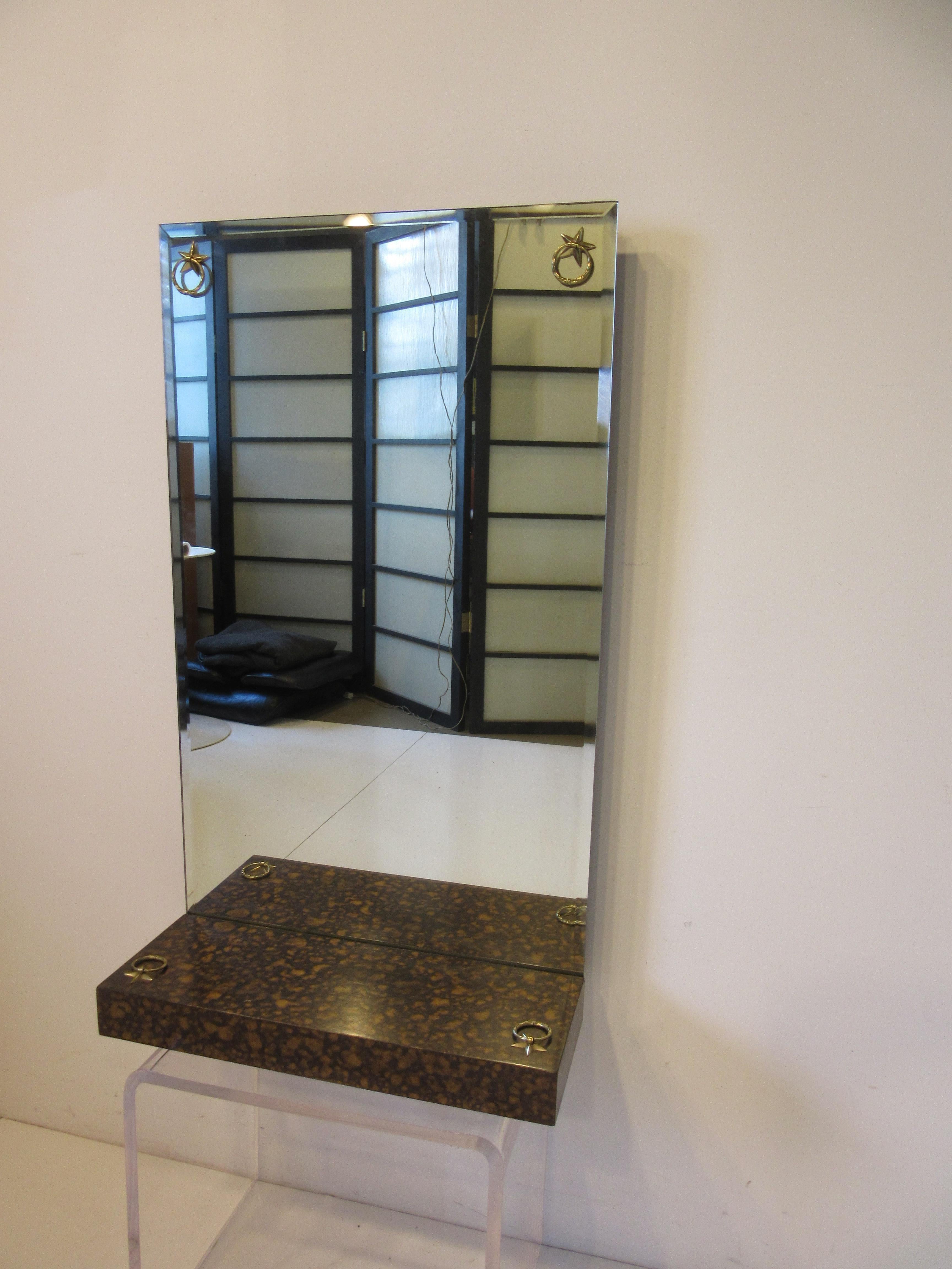 A well crafted mirror by the premiere manufacture Labarge with faux tortoise shell finish , lower shelve platform and brass detail castings . Retains the manufactures label to the backside from the Labarge Mirror Company , the perfect mirror for