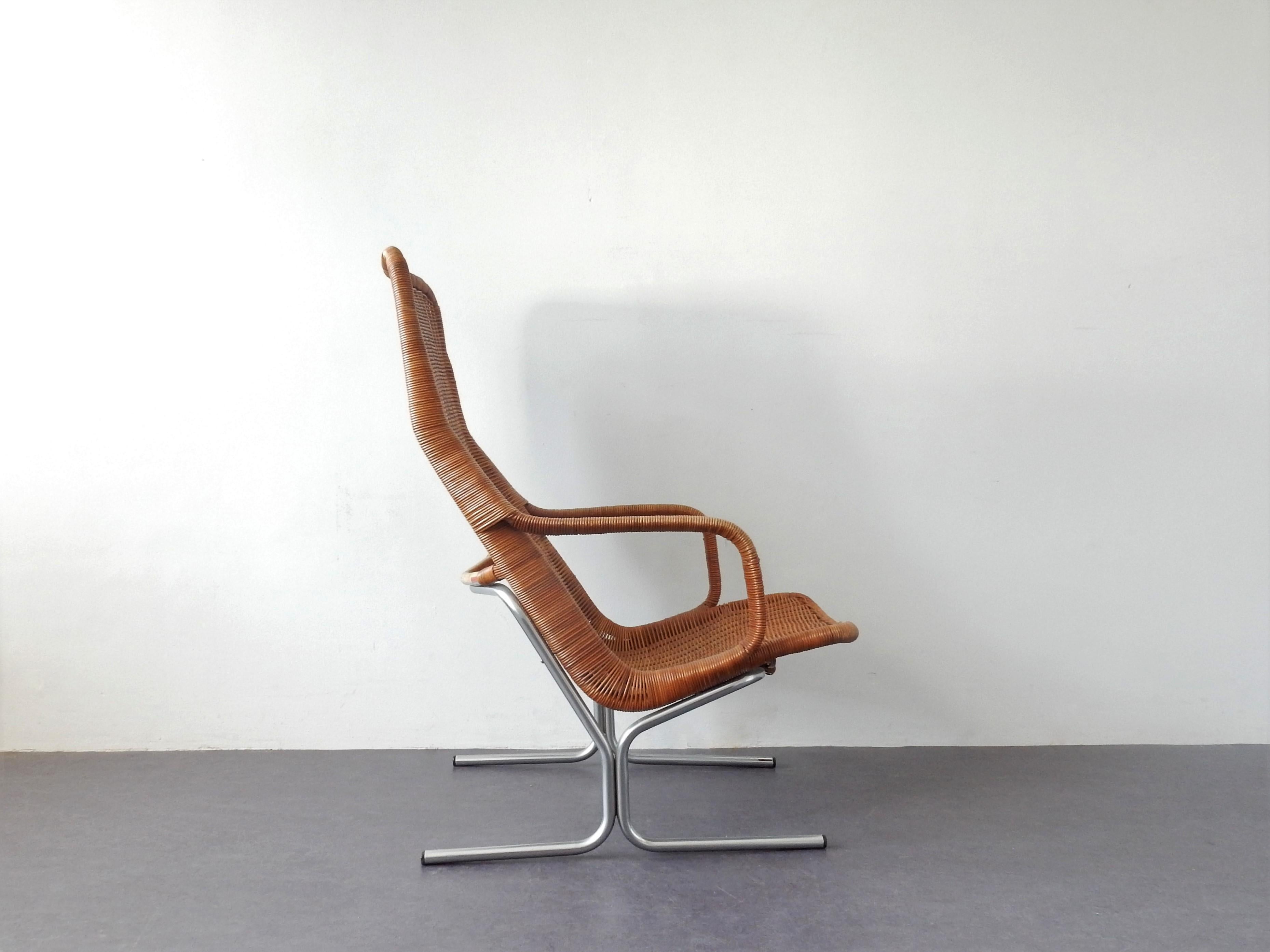 This lounge chair, model 514C, was designed by Dirk van Sliedregt for Gebr. Jonkers (Jonkers brothers) Noordwolde in 1961. The Jonkers brothers were famous for their rattan chairs and furniture. This chair has a webbed cane (high back) seat and