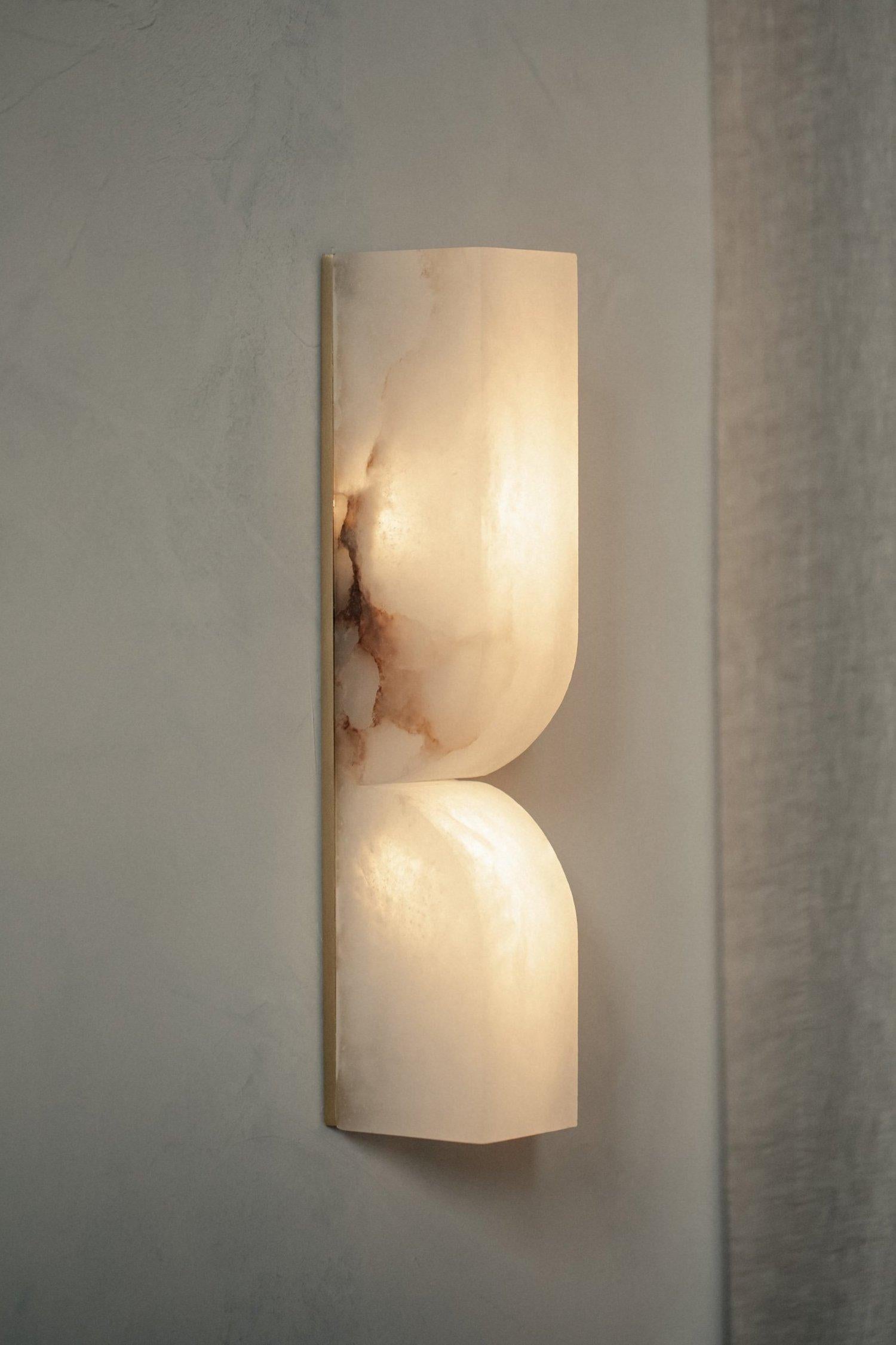 Labra sconce is an exploration of stone as nature’s art, hand-chiseled and carefully shaped to perfection by masters in their craft. Honouring the rich materiality of European alabaster.

Labra is a wall-mounted LED fixture and ornamental