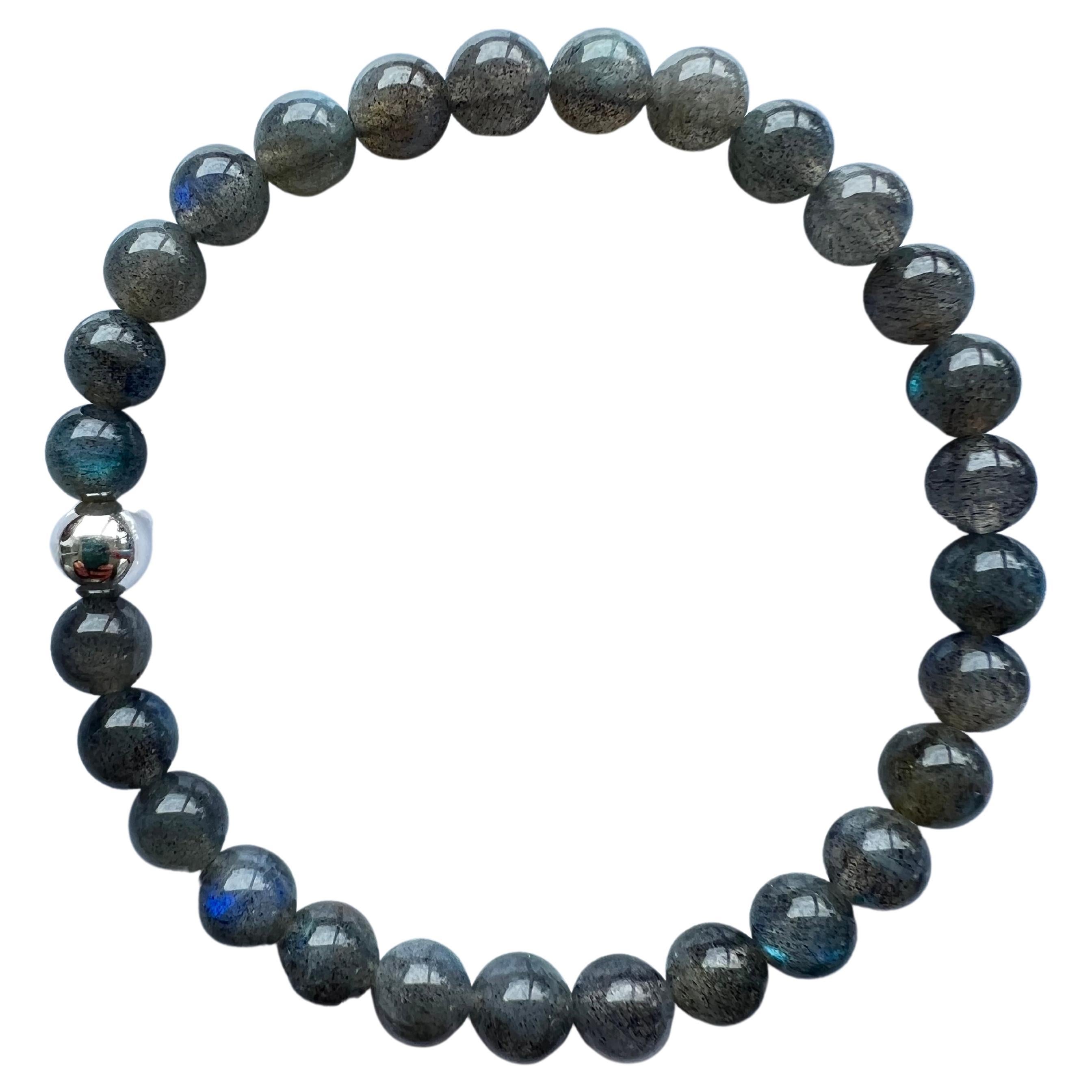 Violet Beaded Bracelet Natural Semi Precious Gem Crown Chakra Silver J Dauphin

Introducing the J Dauphin Labradorite Beaded Bracelet, a stunning marriage of mystical symbolism and timeless elegance. This meticulously handcrafted piece, brought to