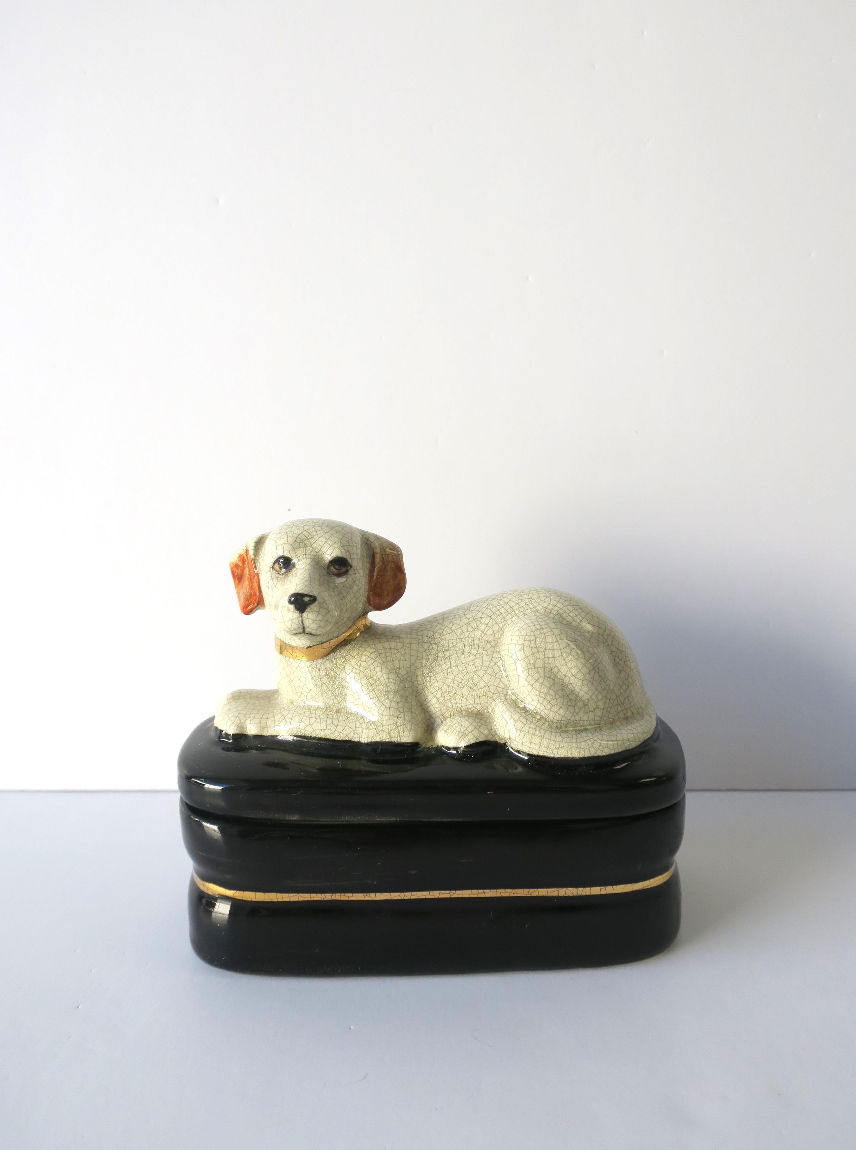 A ceramic Labrador Retriever dog on pillow decorative box, circa mid-20th century. Great as a standalone piece, or to hold small items on desk or jewelry on a vanity, dresser, etc. Colors include black and gold box base, gold collar around dogs'