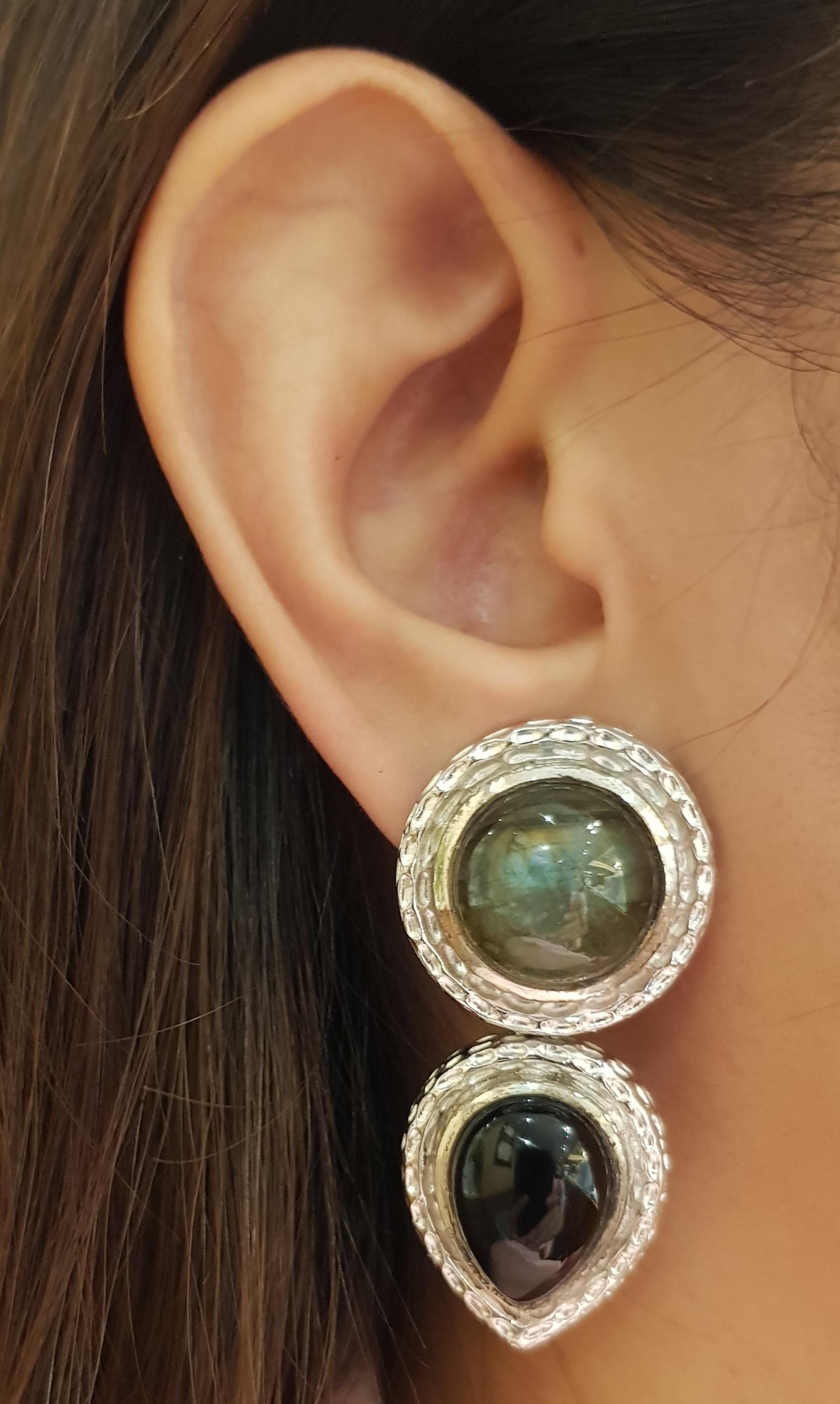 Labradorite and Onyx Earrings set in Silver Settings

Width: 2.4 cm 
Length: 4.7 cm
Total Weight:  34.2 grams

*Please note that the silver setting is plated with rhodium to promote shine and help prevent oxidation.  However, with the nature of