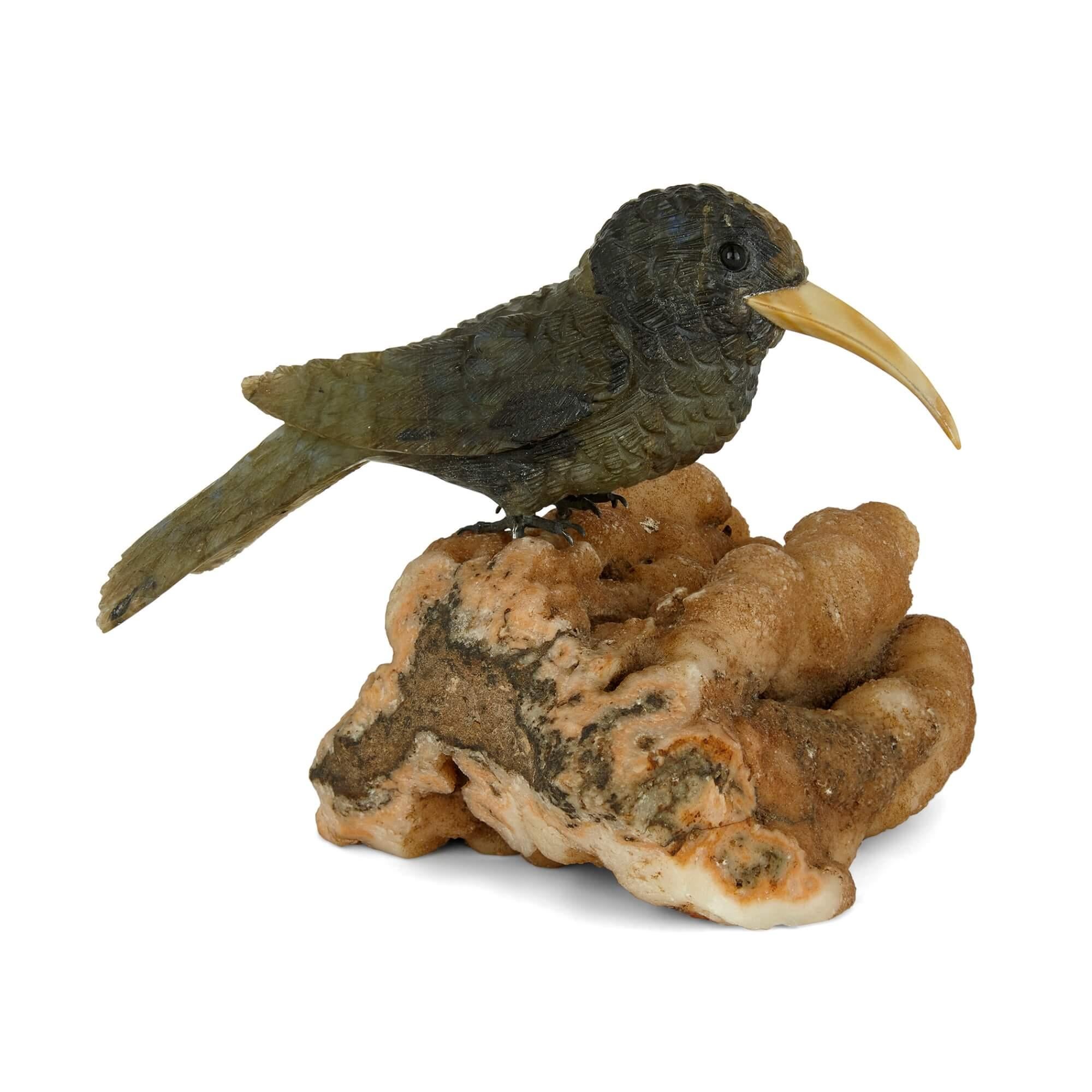 Labradorite and silver bird model 
Continental, 20th Century 
Height 10cm, width 11cm, depth 12cm

Crafted in the 20th century the stone model depicts a hummingbird perched on top of an unusual rock. 

The bird is carved from labradorite, an