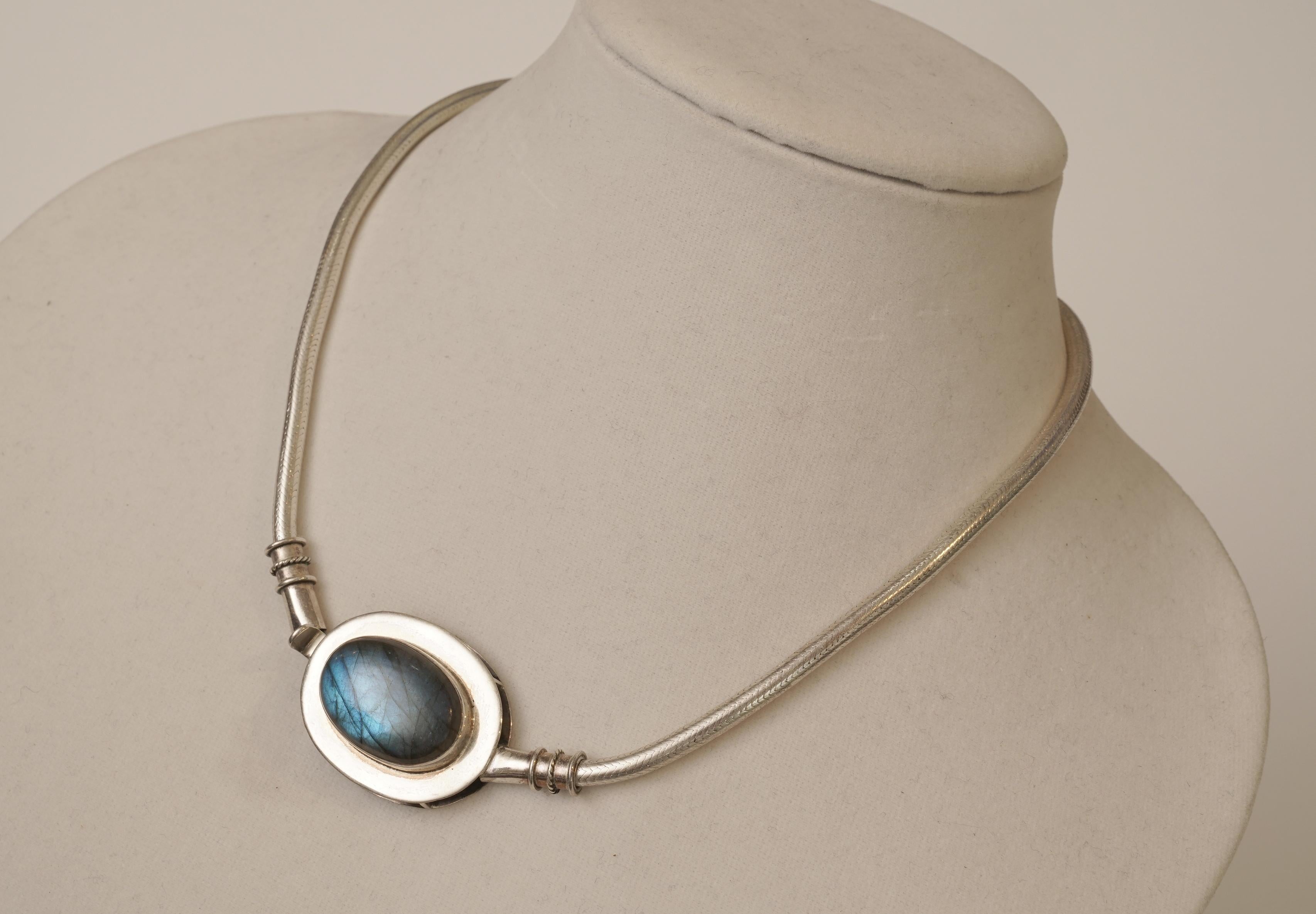 A lovely, large cabochon Labradorite stone centers the supple and dense sterling silver snake chain with an intricate herringbone pattern.  The Labradorite stone itself is of excellent blue quality with an amazing Schiller effect (the radiance and