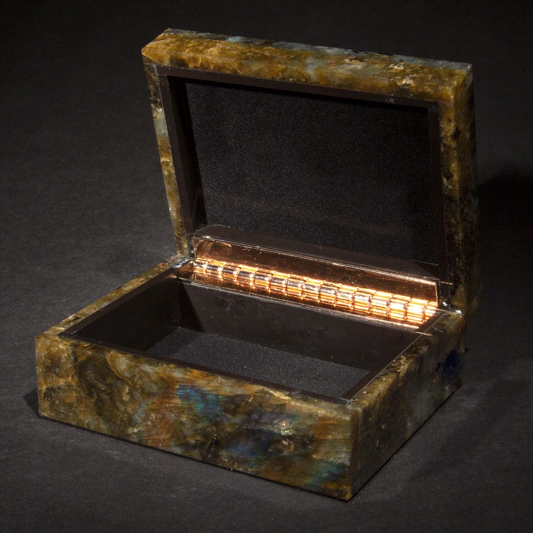 This Labradorite Box, with dimensions of 4.25 inches by 3.5 inches and a height of 1.75 inches, is a stunning piece that marries utility with the mesmerizing beauty of labradorite. Known for its captivating play of colors, labradorite displays a
