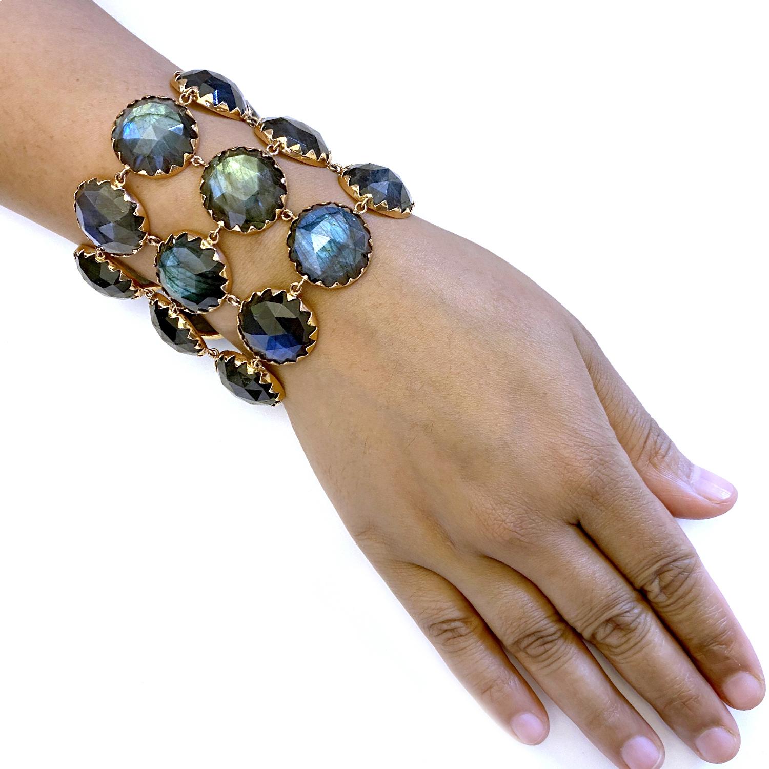 Broad Beautiful Labradorite Bracelet set in 18K Rose Gold. Wear this bracelet to your most important event and never be forgotten. Each stone is handcut and very finely covered with gold bezel on sides with a triangle motif. It is a slide in
