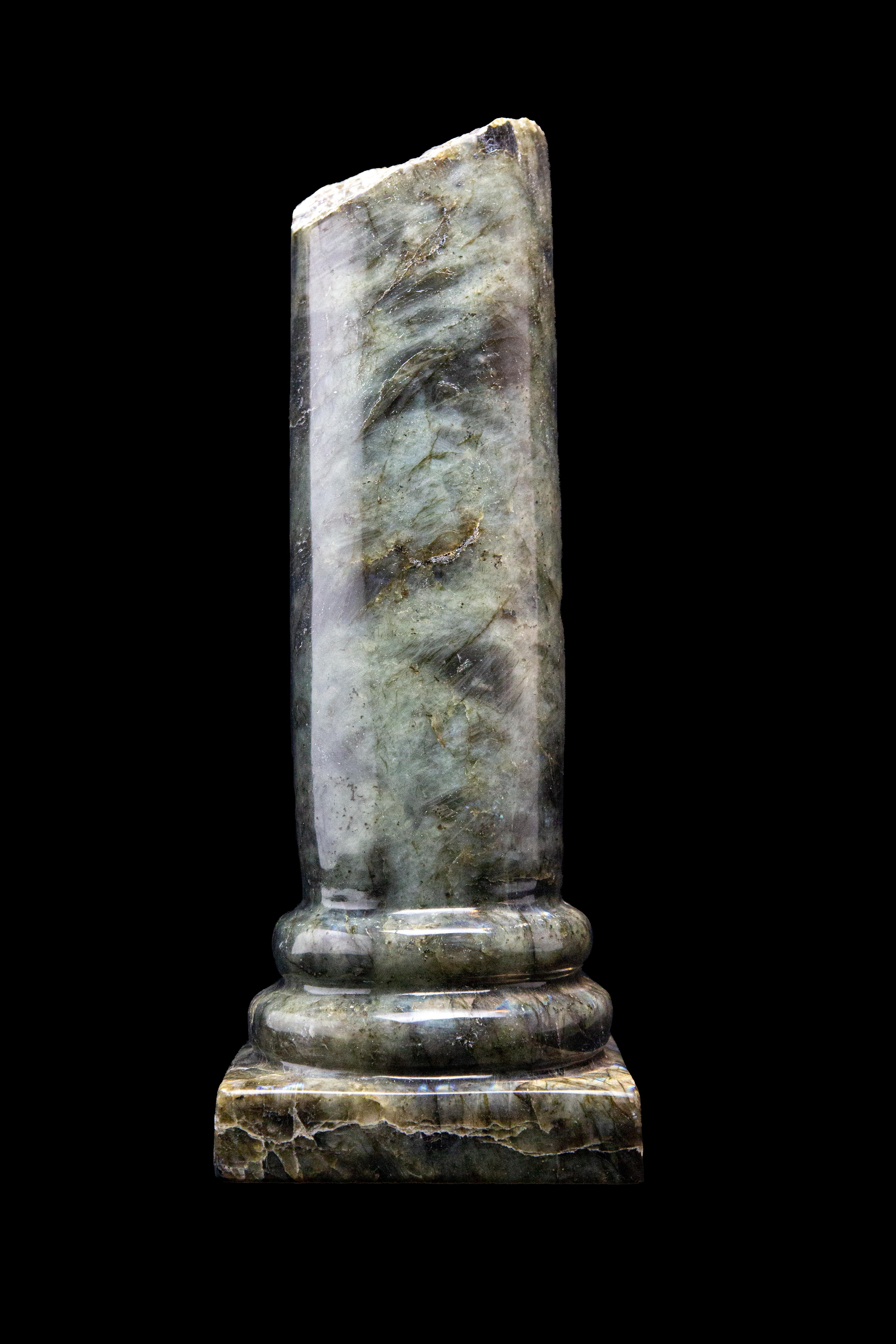 This stunning hand carved Labradorite Column is a unique and eye-catching piece that will add a touch of elegance and mystique to any space. Labradorite is a stone of transformation, protection and intuition, with a beautiful iridescent flash that