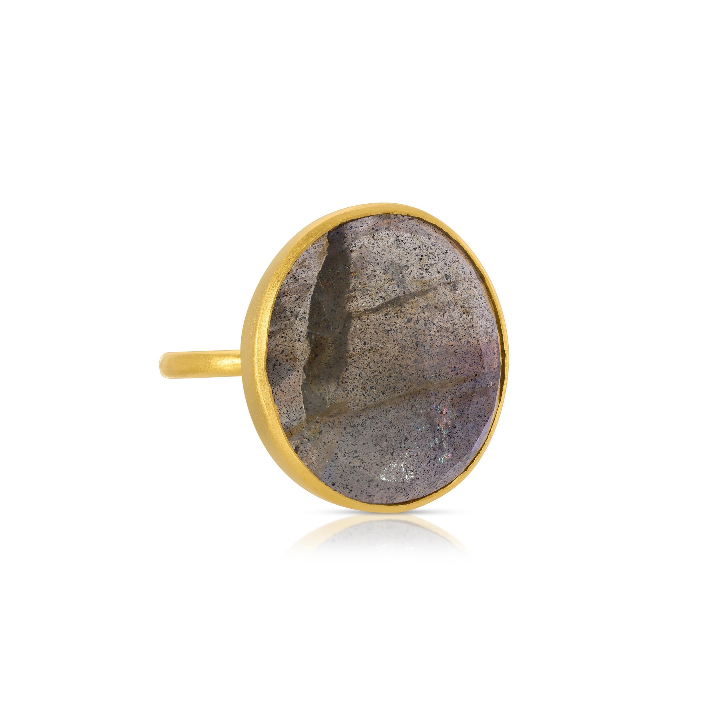 A fabulous cocktail featuring a beautiful dome shaped gemstone. This ring features an 18 Carat natural Labradorite with an exceptional electric blue undertone in a modern raised setting. This ring is set in 22 Karat Gold overlay Silver.
