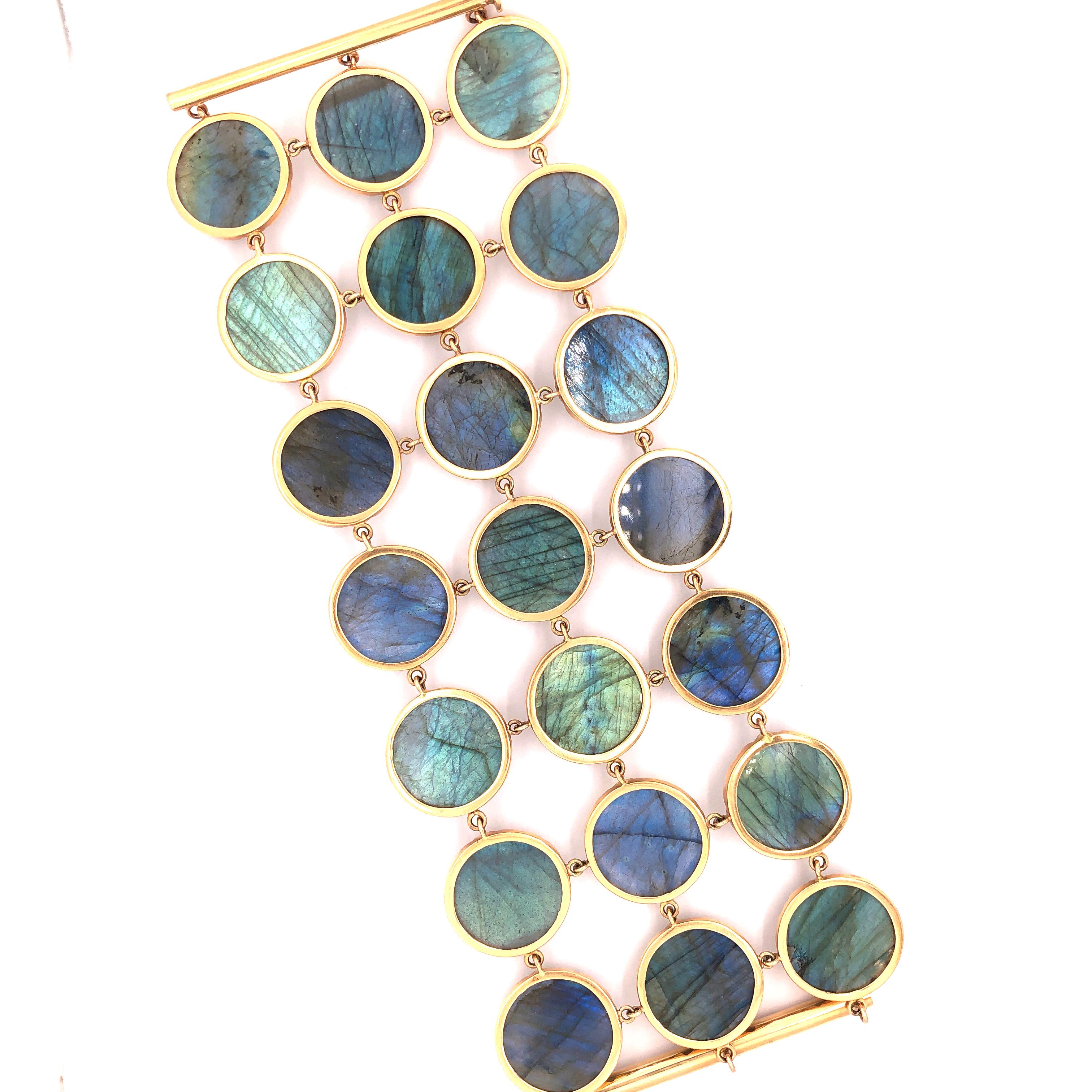 Broad Beautiful Labradorite Bracelet set in 18K Rose Gold. Wear this bracelet to your most important event and never be forgotten. Each stone is handcut and very finely covered with gold bezel on sides with a triangle motif. It is a slide in