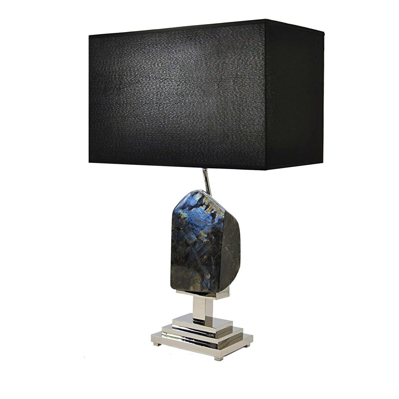 This elegant lamp will make a powerful statement in any room it is placed. A large irregularly-cut piece of labradorite is what constitutes the body of this lamp and is the first thing the eye is drawn to. This breathtaking stone from Madagascar is