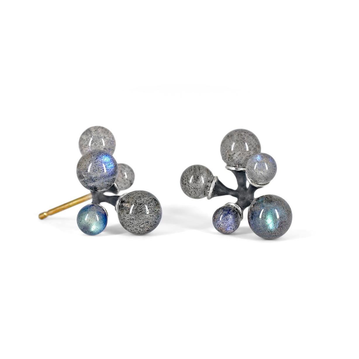 Micro Jacks Earrings handcrafted by renowned jewelry designer John Iversen in oxidized sterling silver with ten assorted size labradorite spheres on 18k yellow gold posts with sterling silver backs. Stamped 750. Backs stamped 585.

About the Maker -