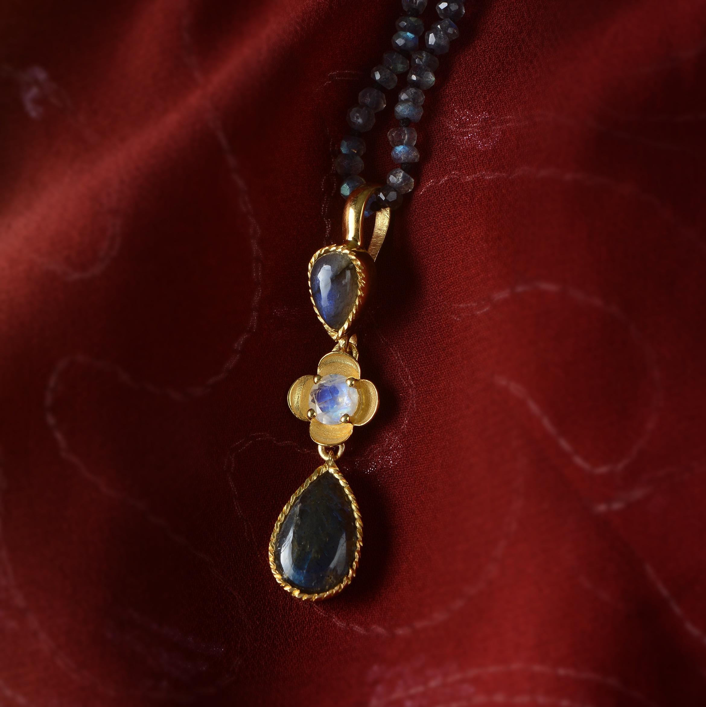 This beautiful labradorite moonstone teardrop shaped pendant has been handmade in our workshops.

It is made in 24k gold plate coated over sterling silver and is from a limited edition. The pendant has matching earrings and ring. It comes with a 26