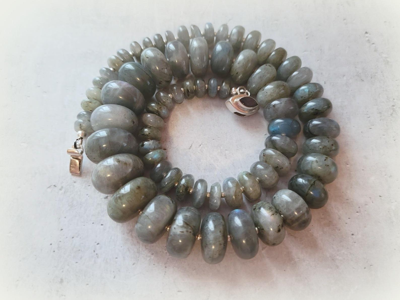 The length of the necklace is 19.5 inches (50 cm). The size of the smooth rondelle beads varies from 8 mm to 18 mm. 
The color of the beads varies from light gray to soft blue to dark gray. The beads have a delightfully soft, gentle, grey-blue tone