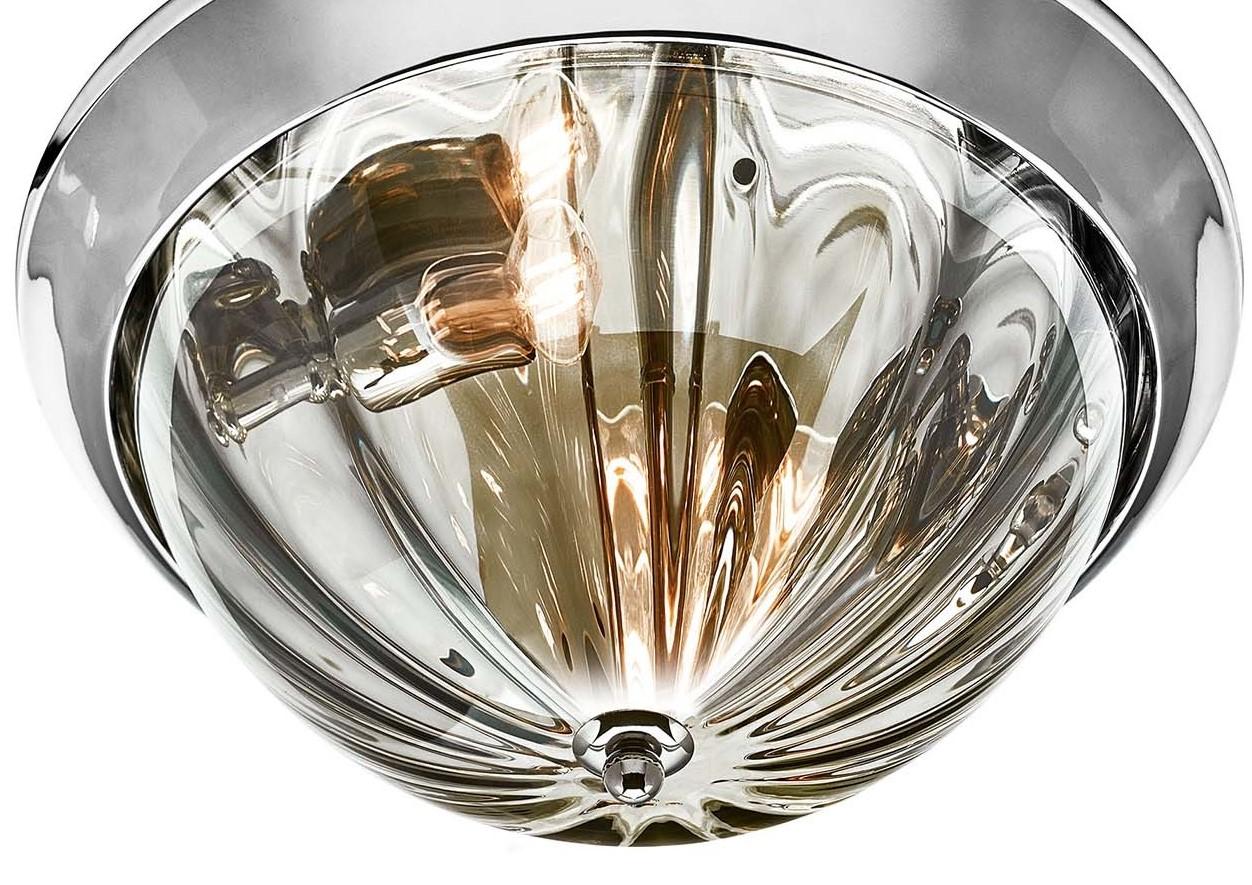 This captivating ceiling lamp features a flush-mount design with a contemporary allure that will provide diffused and decorative illumination in any room in which it is placed. Framed in chrome-plated metal, the smoked glass diffuser is hand blown