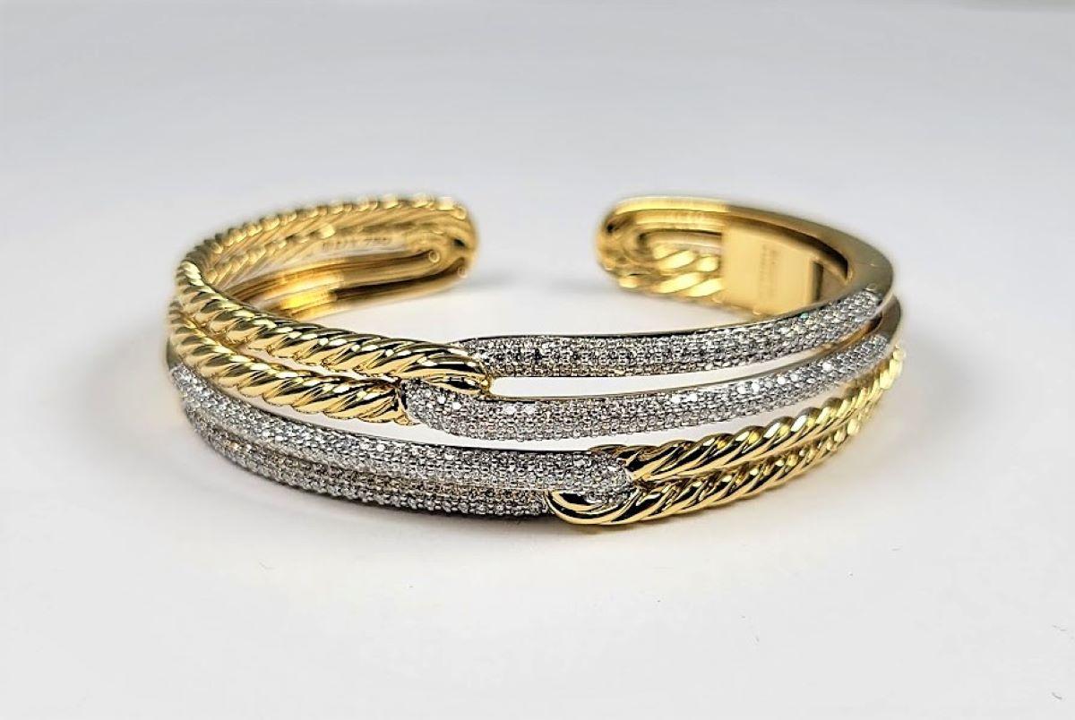 From the Labyrinth, Double Loop collection, this 18 karat yellow gold and stainless steel, cuff bracelet has approximately 2.00 cts of round diamonds. A classic from David Yurman!