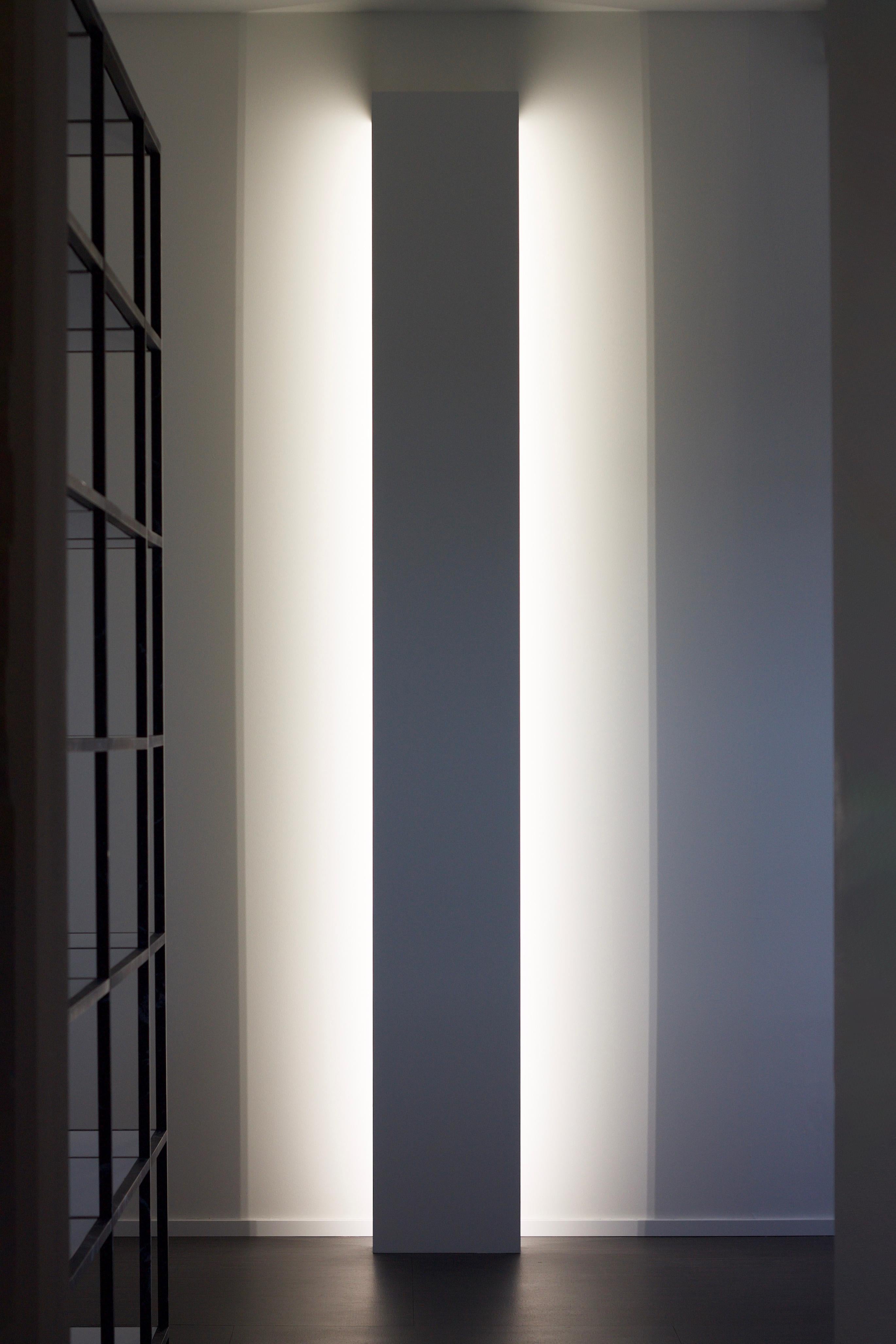 A unique design in its simplicity. Tall, stunning, impressive, capable of turning any corridor into a scenic passage or to create a sequence of depths and lights when used in sequence in a larger space. The LED lights will cast firm shadows and