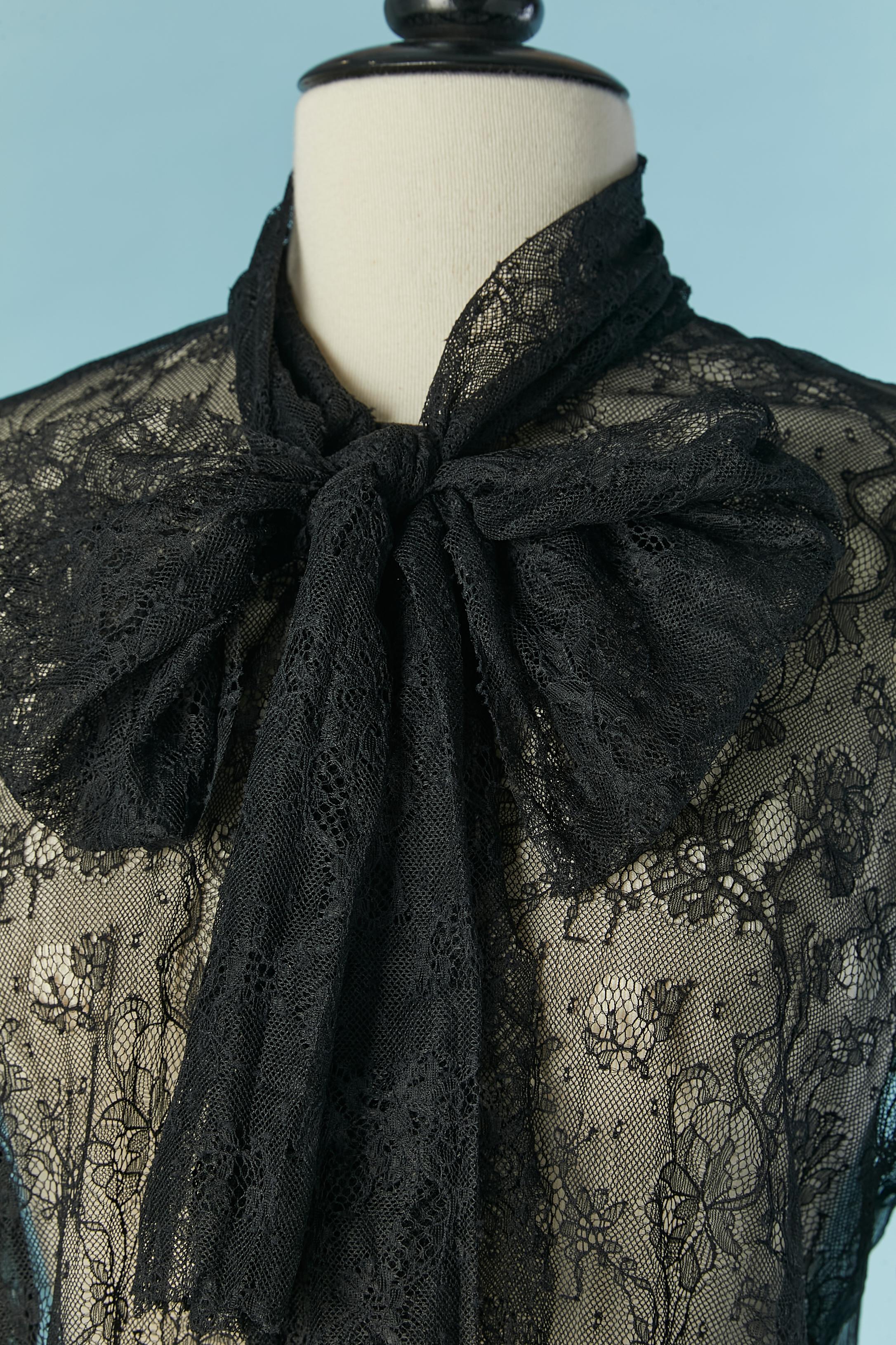 Lace and silk chiffon see-through black shirt with bow tie collar and bow-tie button closure. Only the front of the shirt is in lace, the back and the sleeves are in silk chiffon. 
Lace composition: polyester. 
Authenticity hologram. 
SIZE 48 (It)
