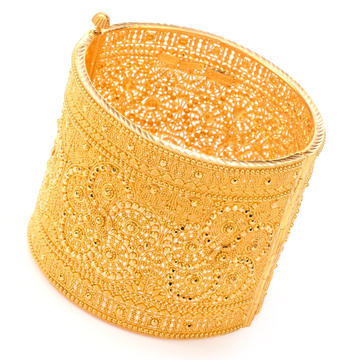 A solid 18k yellow gold  bangle bracelet. This  geometric lace design bracelet will fit approximately a 6