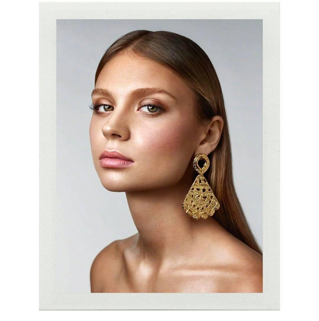 The Morgana earrings are part of the signature collection of crochet lace designed by Alexandra Koumba.
These large feature earrings are stunning to wear and surprisingly light in weight! 
They are plated in 18k gold.

Length: 3.15'' / 8 cm

 Also