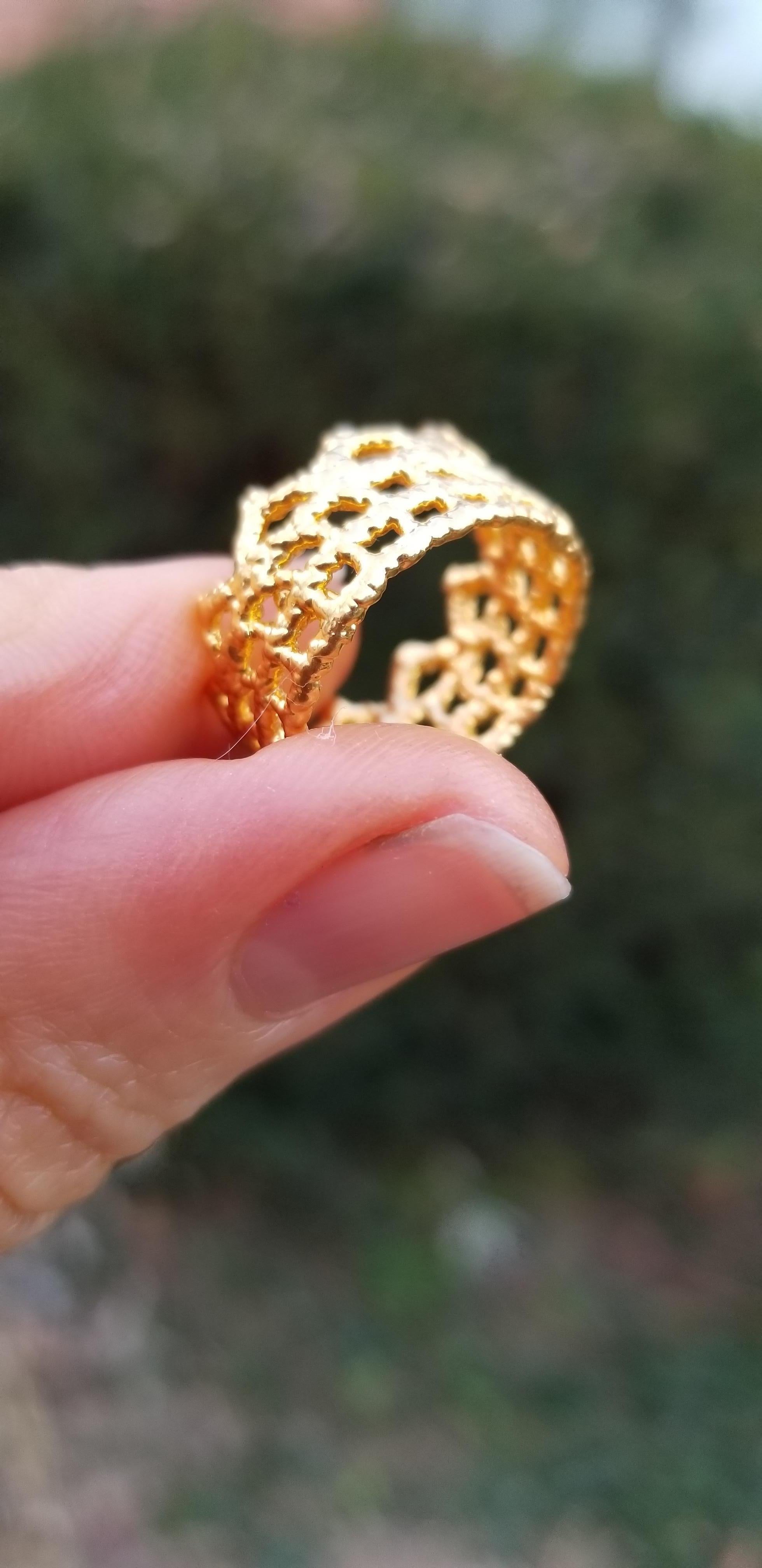 This piece is a delicate treasure - like a golden crown for the finger.
The artist, Monika Kunuttson, has. Become renown for her jewelry which is cleverly constructed of lace, which is then magically dipped in a bath of pure 18k gold, creating a
