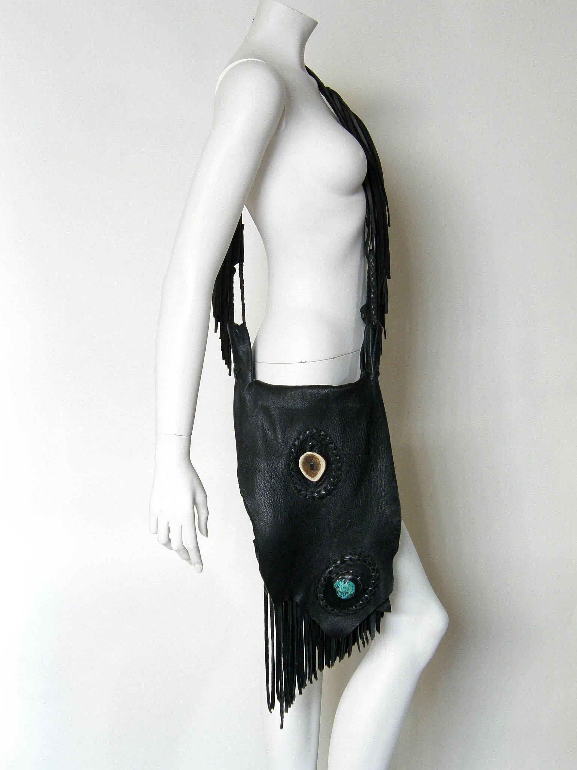 This handcrafted leather shoulder bag is made from wonderfully soft and thick leather with a pebbled finish, probably deerskin. It has a bohemian chic style with a touch of western. The the body of the bag utilizes the irregular edge of the hide to