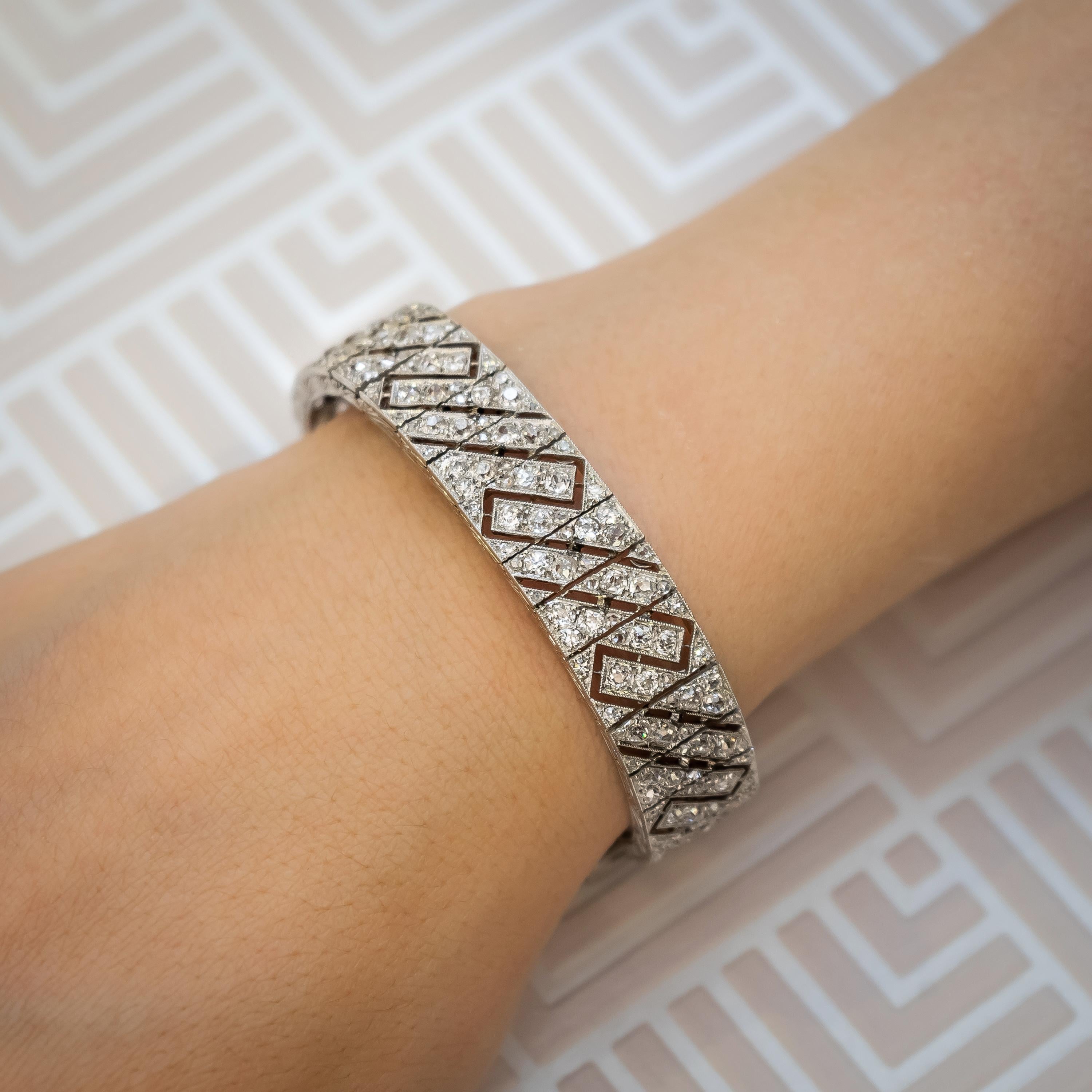 A Lacloche Frères, Art Deco diamond bracelet, set with old-cut diamonds, weighing approximately 14.50ct, in a geometric, diagonal design, of interlocking rows, with millegrain edges, with engraved sides, mounted in platinum, with French dog marks