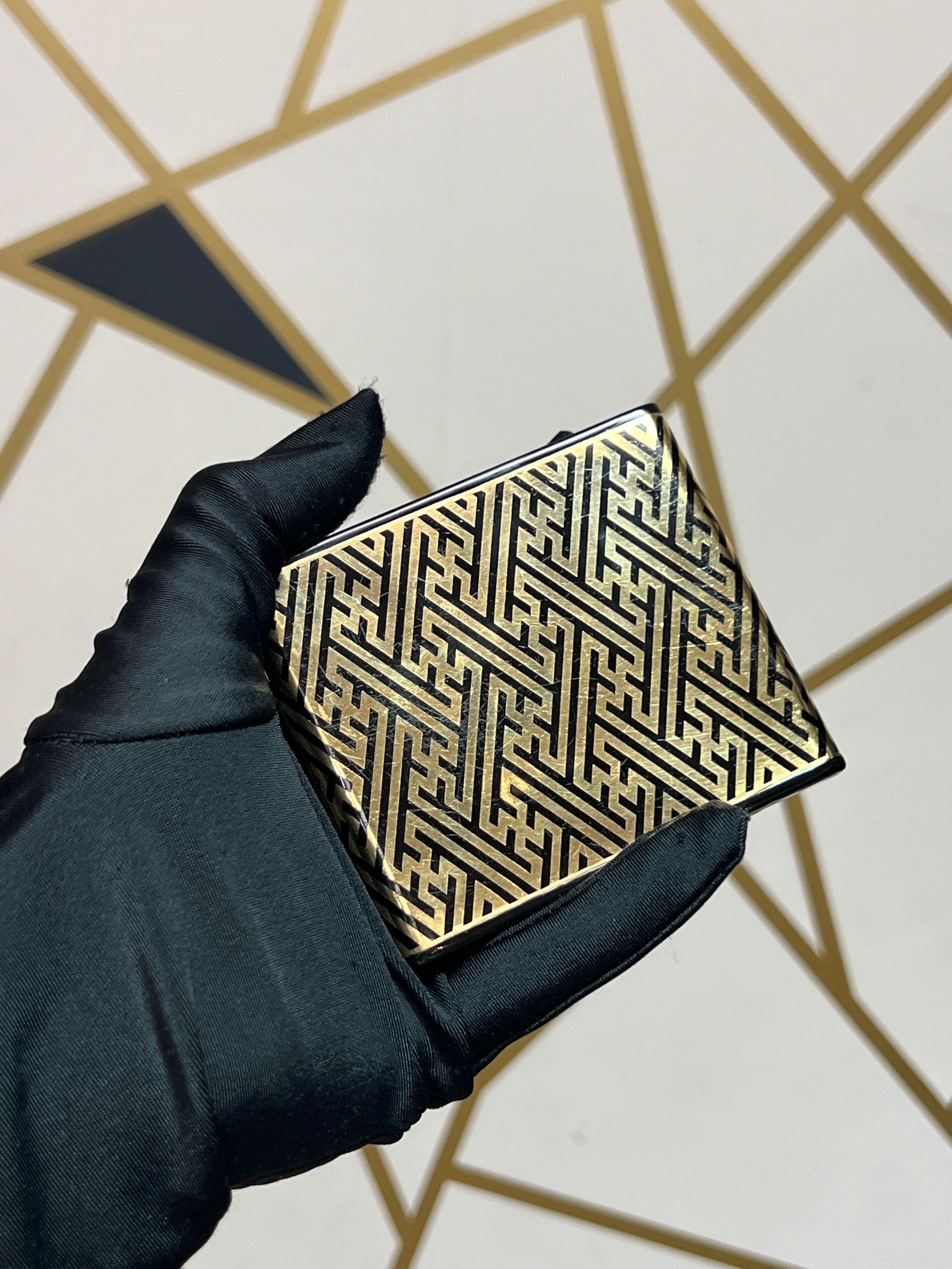 Lacloche Freres Gold and Enamel Cigarette Case

A gold cigarette case adorned with a black enamel geometric design.

Signed Lacloche Frères Paris and numbered
Stamped with French assay, workshop marks, and British import marks

Approximate