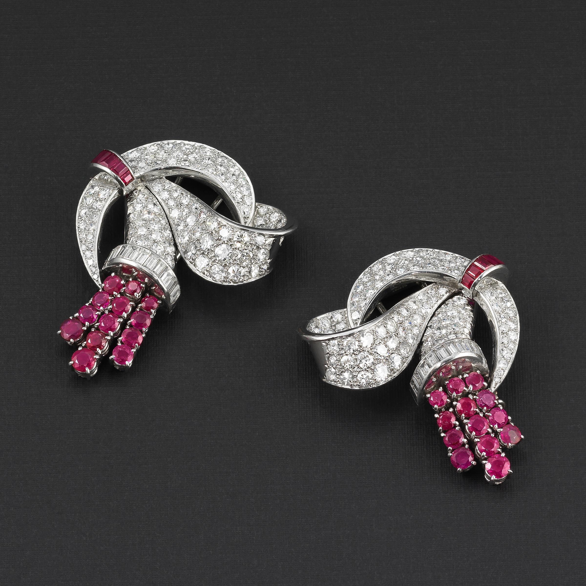 Exceptional pair of Lacloche Freres clip brooches (convertible to earrings) from the Art Deco prime 1930s period featuring diamonds and Burma rubies set in platinum and 18K white gold:
- Highly important and one-of-a-kind Art Deco creation from the