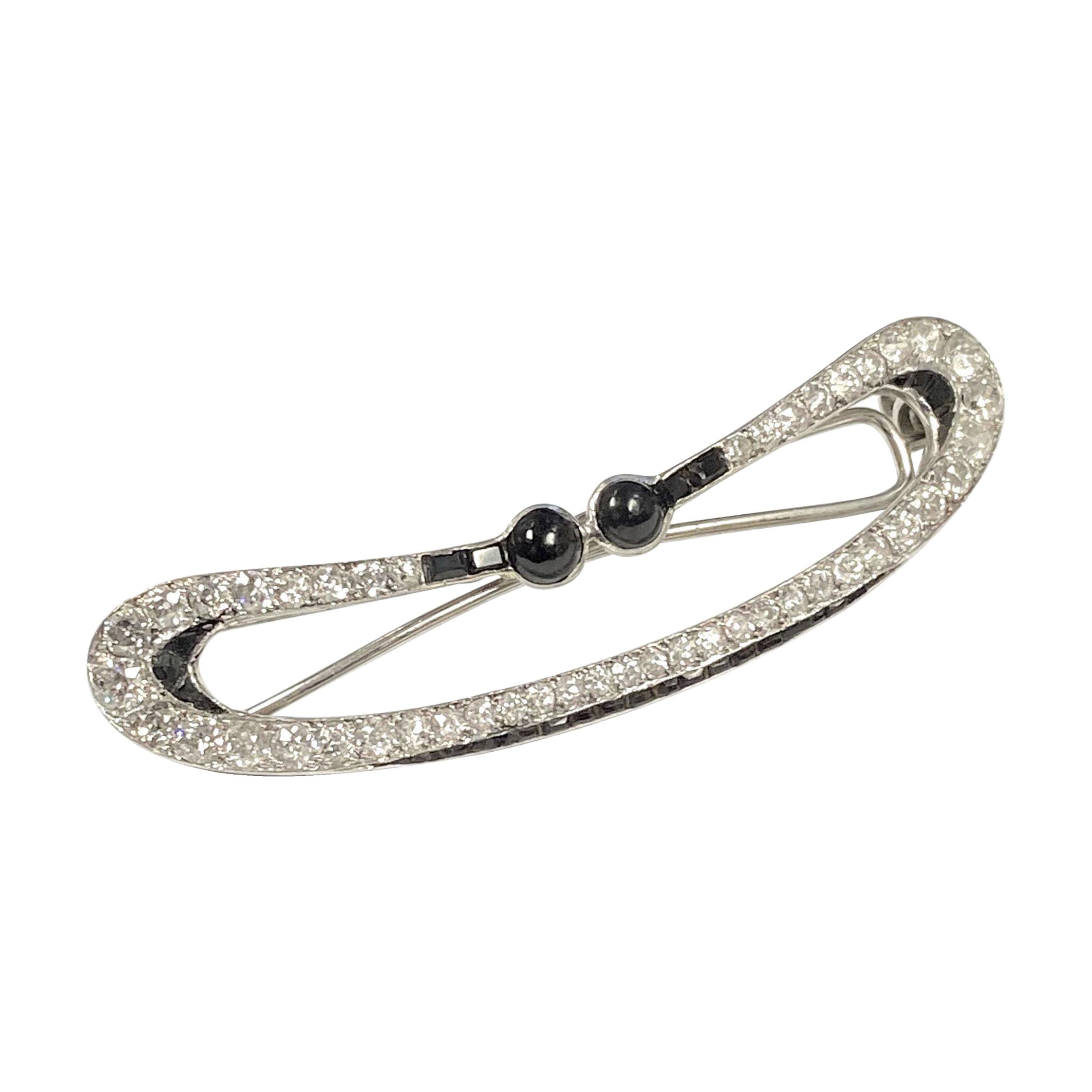 Circa 1930s Lacloche Freres Platinum Hair Barrette, measuring 2 3/8 inches in length X 1/2 inch wide, set with Old cut Diamonds totaling 2 Carats and further set with Onyx. 