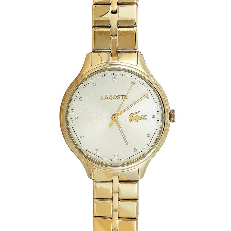 This is the Lacoste Constance watch, reference number 2001008. It is presented with a gold-tone stainless steel case that measures 38 mm in diameter. The case is water-resistant to 30 meters and mounted onto a matching gold-tone stainless steel