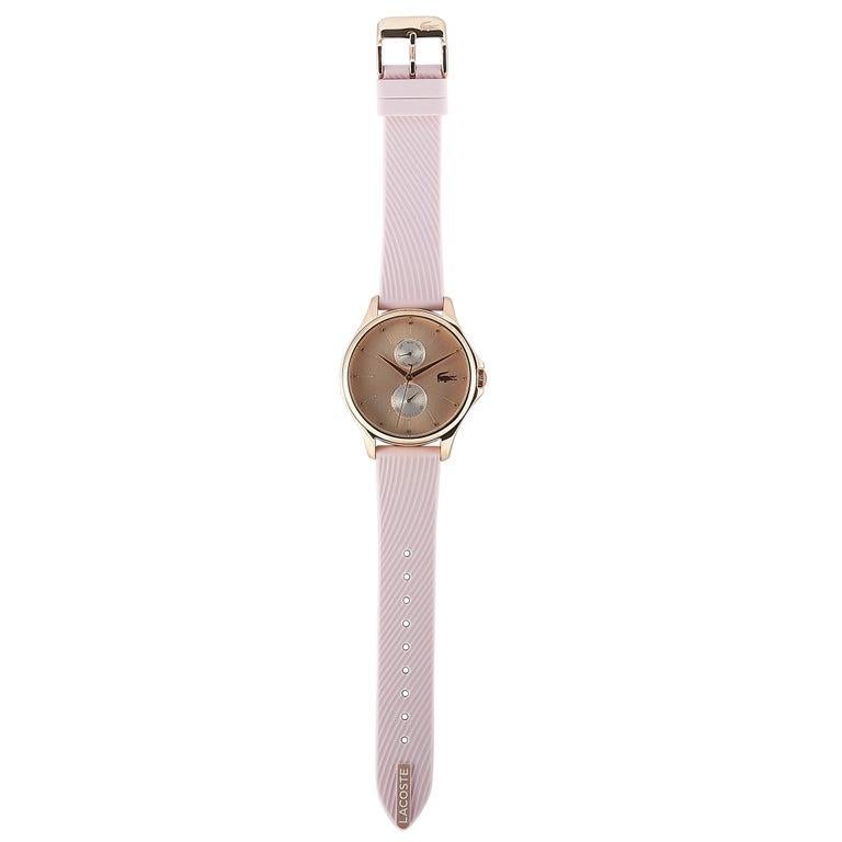 This is the Lacoste Kea watch, reference number 2001025. It is presented with a rose gold-tone stainless steel case that measures 38 mm in diameter. The case is water-resistant to 30 meters and mounted onto a light pink silicone strap, secured on