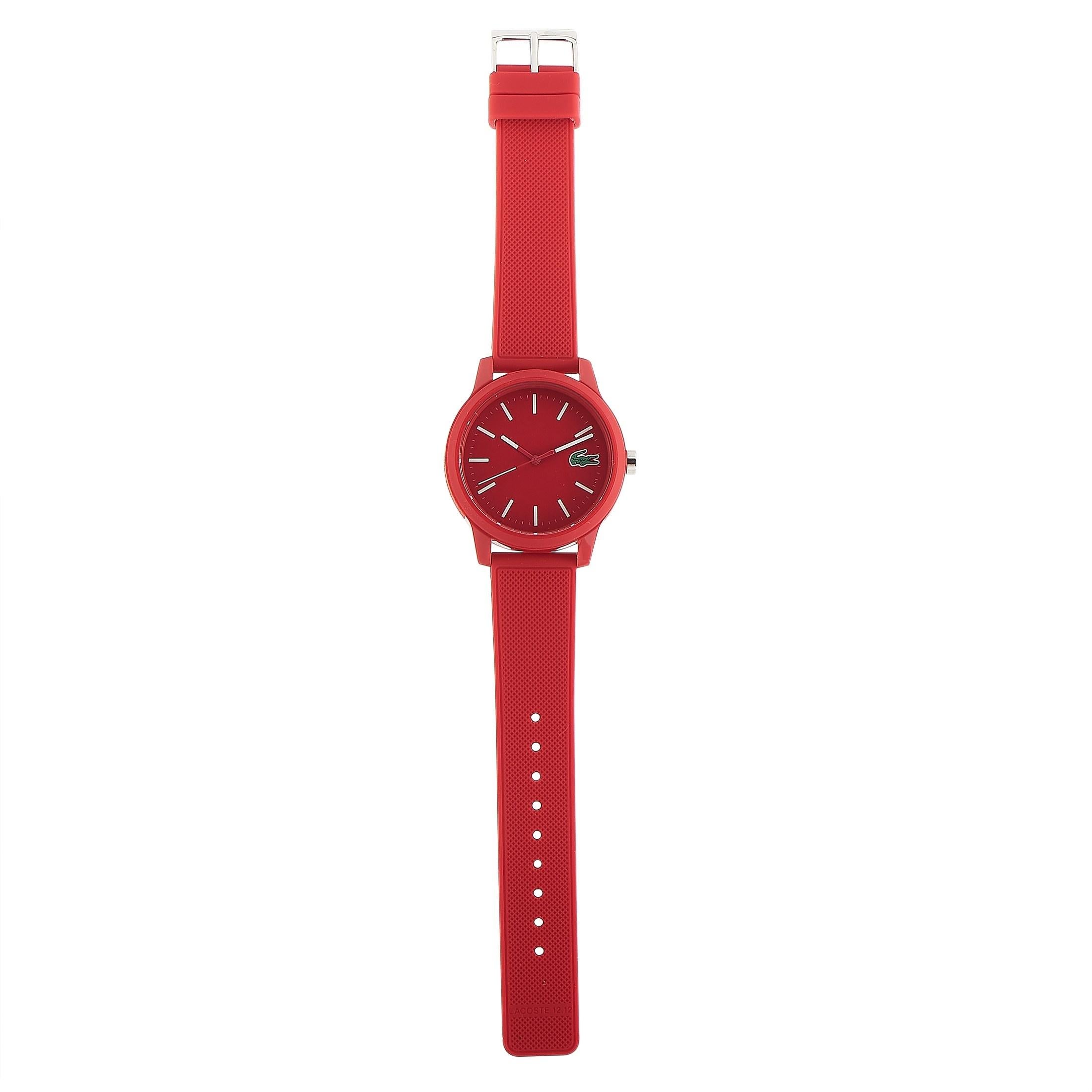The Lacoste.12.12 watch, reference number 2010988, is presented with a red TR90 case that measures 42 mm in diameter and boasts stainless steel back. This model is powered by a quartz movement and indicates hours, minutes and seconds on the red