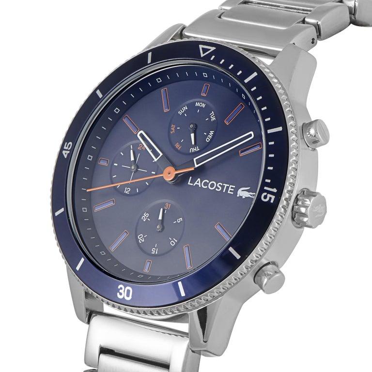 This is the Lacoste Key West watch, reference number 2010995. It boasts a 44 mm stainless steel case that is presented on a stainless steel bracelet. The case is water-resistant to 50 meters. The blue dial features central hours, minutes and