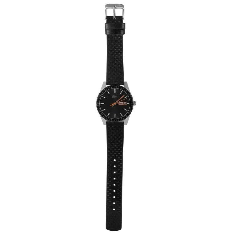 This is the Lacoste Legacy watch, reference number 2010982. It boasts a 42 mm stainless steel case that is presented on a black leather strap, secured on the wrist with a tang buckle. The case is water-resistant to 50 meters. The black dial features