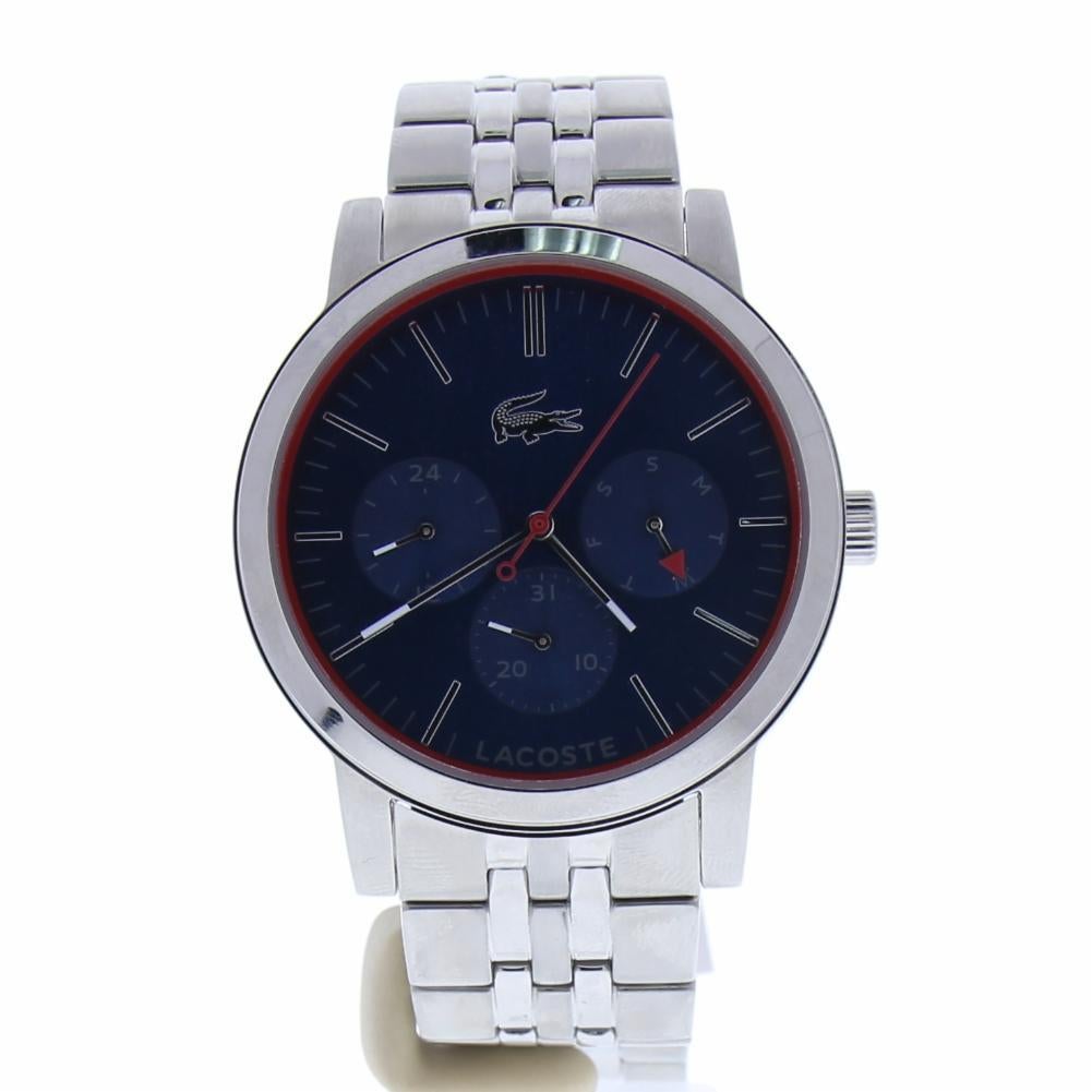Lacoste Metro Reference #:2010878. Stainless steel case. Silver-tone stainless steel bracelet features a fold-over clasp closure with push-button release. Round face. Three-hand analog display with quartz movement. Blue dial features silver-tone