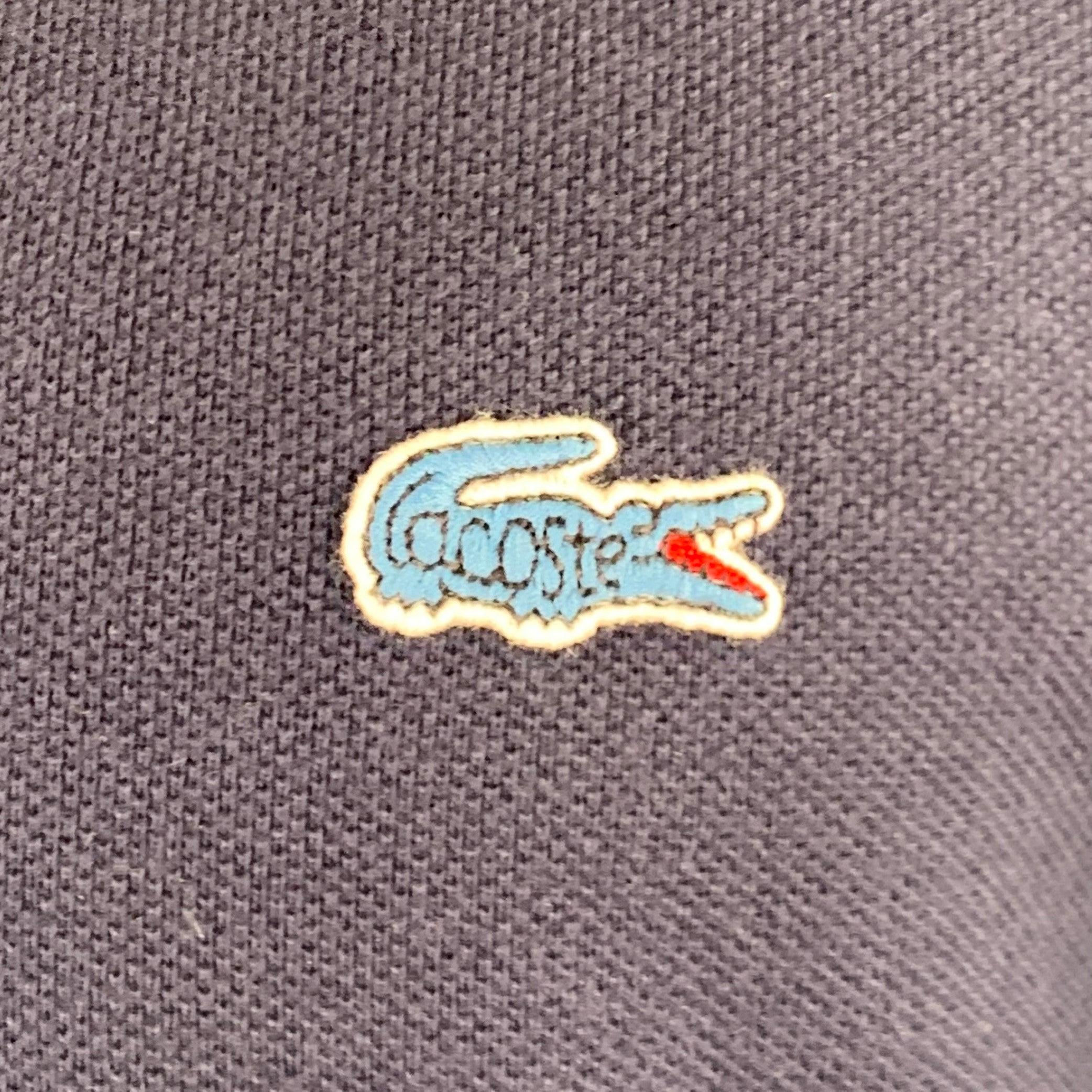 LACOSTE for J.CREW polo in a navy cotton fabric featuring short sleeves and half placket button closure. Excellent Pre-Owned Condition. 

Marked:   FR 4 

Measurements: 
 
Shoulder: 18 inches Chest: 42 inches Sleeve: 9.5 inches Length: 28.5 inches 
