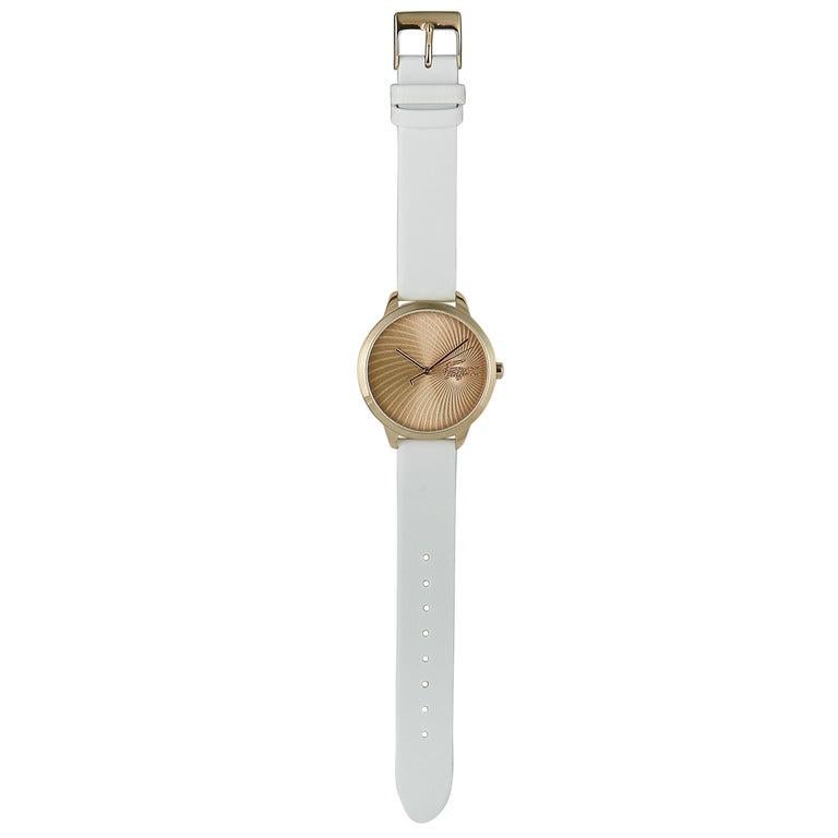 This is the Lacoste Lexi watch, reference number 2001068. It boasts a 38 mm stainless steel case that is presented on a white leather strap, secured on the wrist with a tang buckle. The case is water-resistant to 30 meters. The watch is powered by a