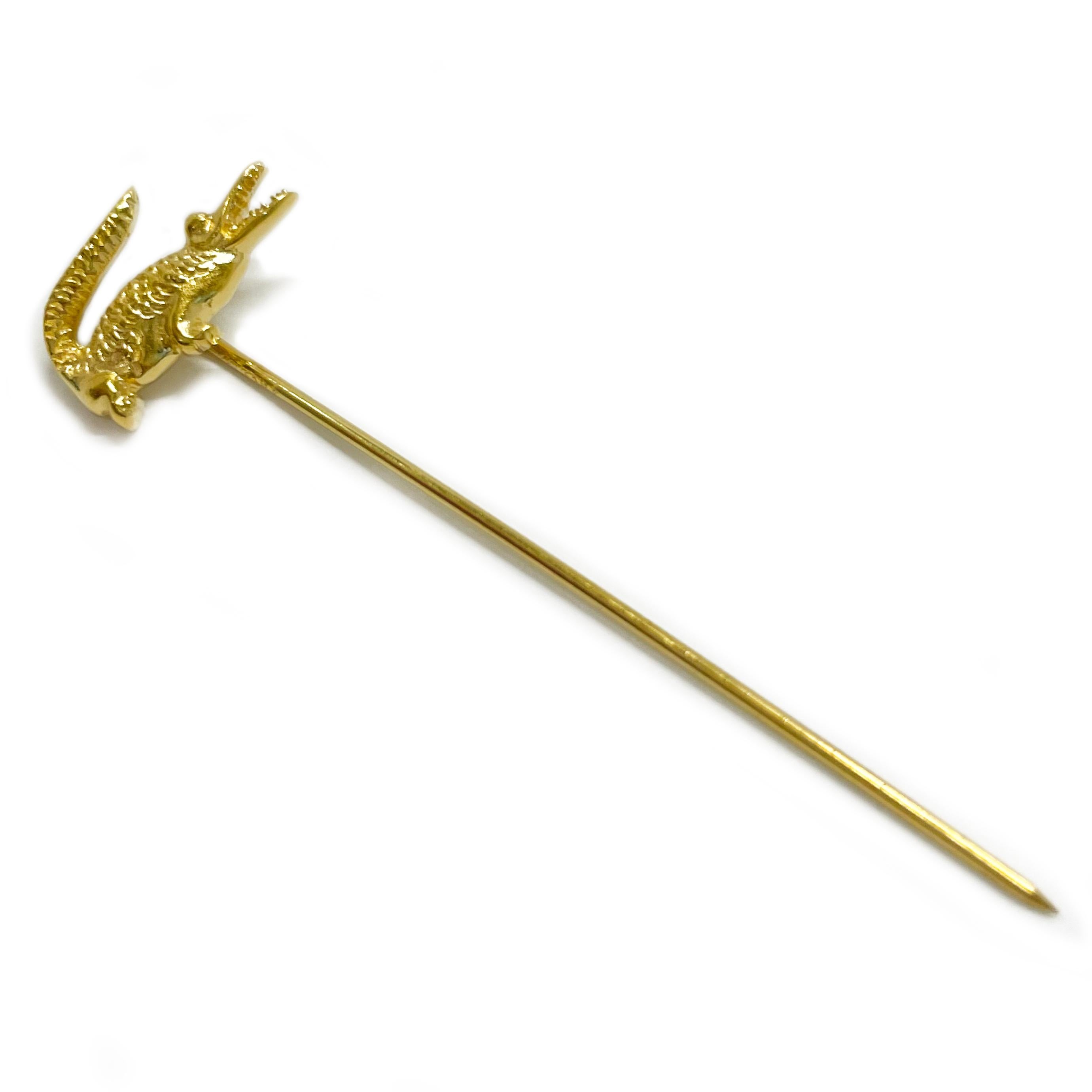14 Karat Lacoste Yellow Gold Alligator Stick Pin. This little fellow has a highly textured body, it's mouth is open and the teeth are visible. The pin measures 8 x 15mm. The total length of the pin is 2.25