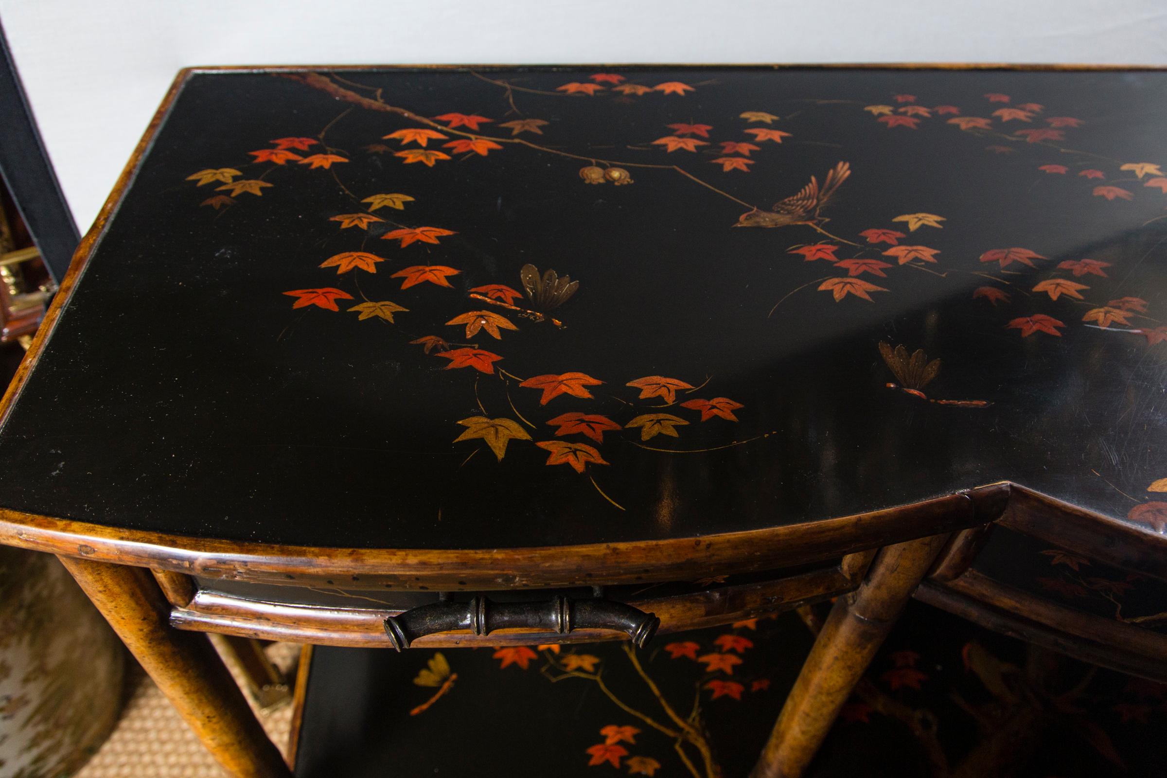 Black lacquer designed in the Asian Style with birds, flowers, leaves and vines.
Three drawers below the top tier. Mirrored back.
It could be used for books, or displays of collections.
Bearing a brass plate 