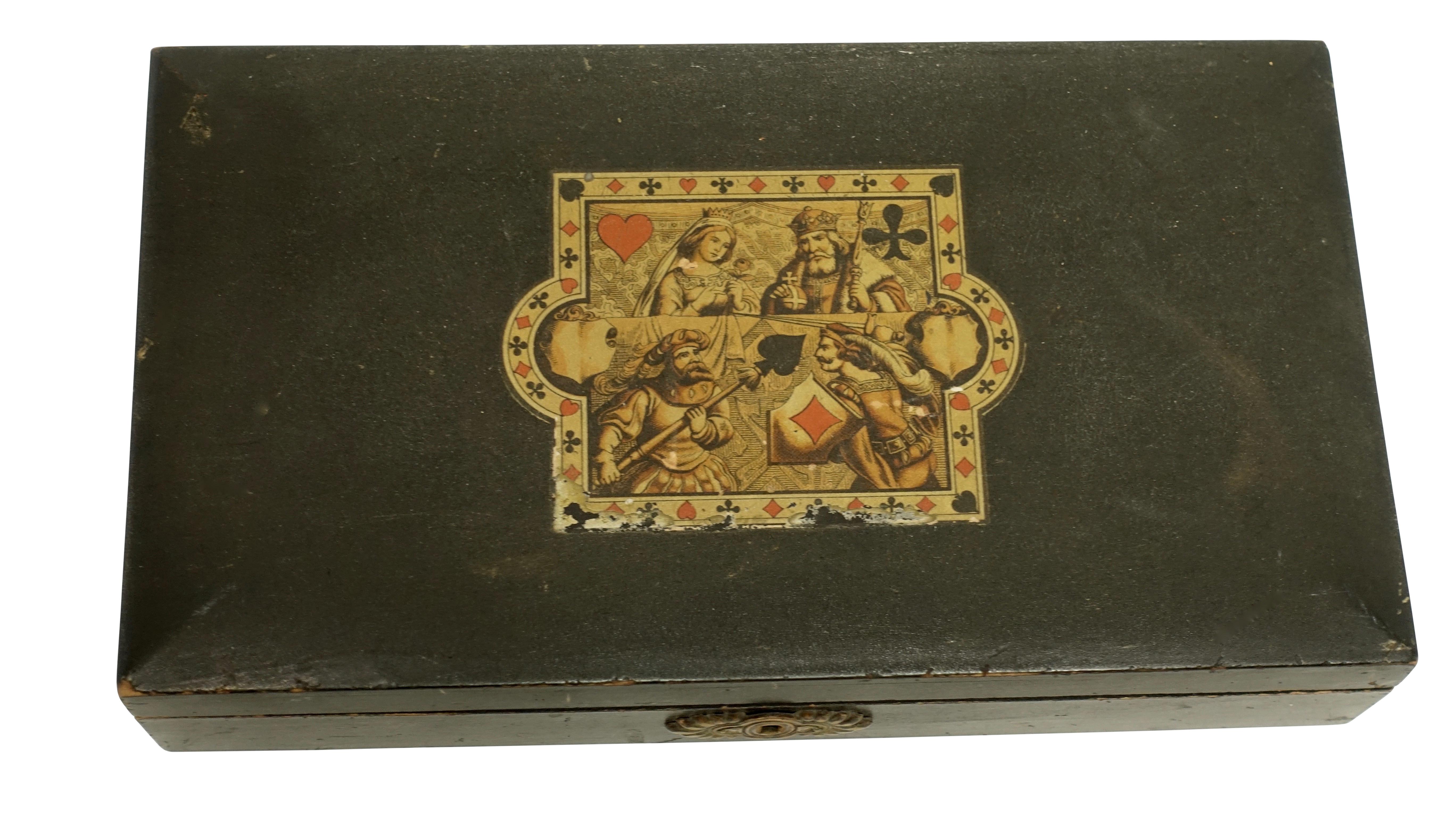 Lacquer and stenciled game box, having four fitted boxes inside with gaming pieces and two decks of hand colored playing cards, one deck with 41 cards and the other with 50. Overall in very good condition. European 19th century.