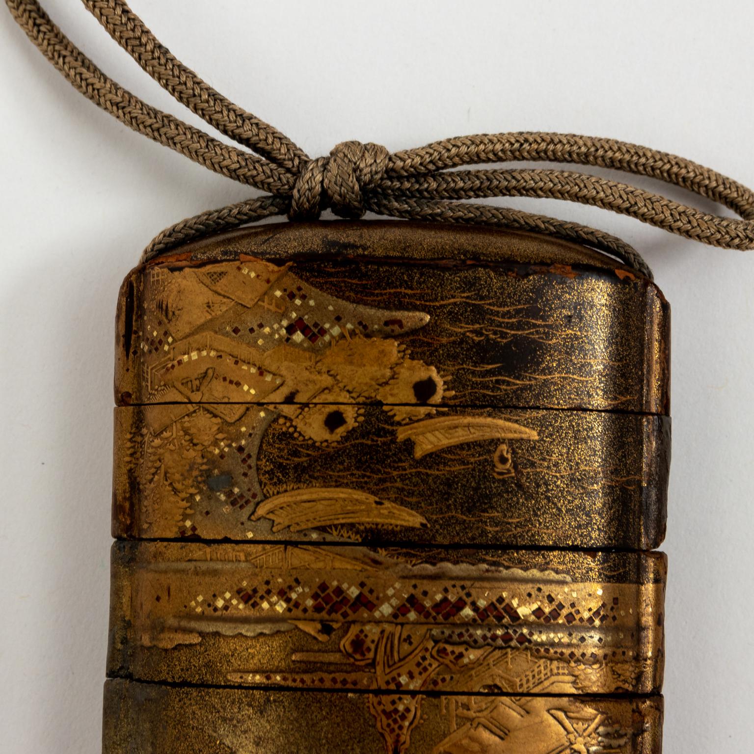 Circa mid-19th century Japanese lacquer inro with spherical ojime and round Zitan or rosewood netsuke which opens to reveal a small storage space for poison pill.